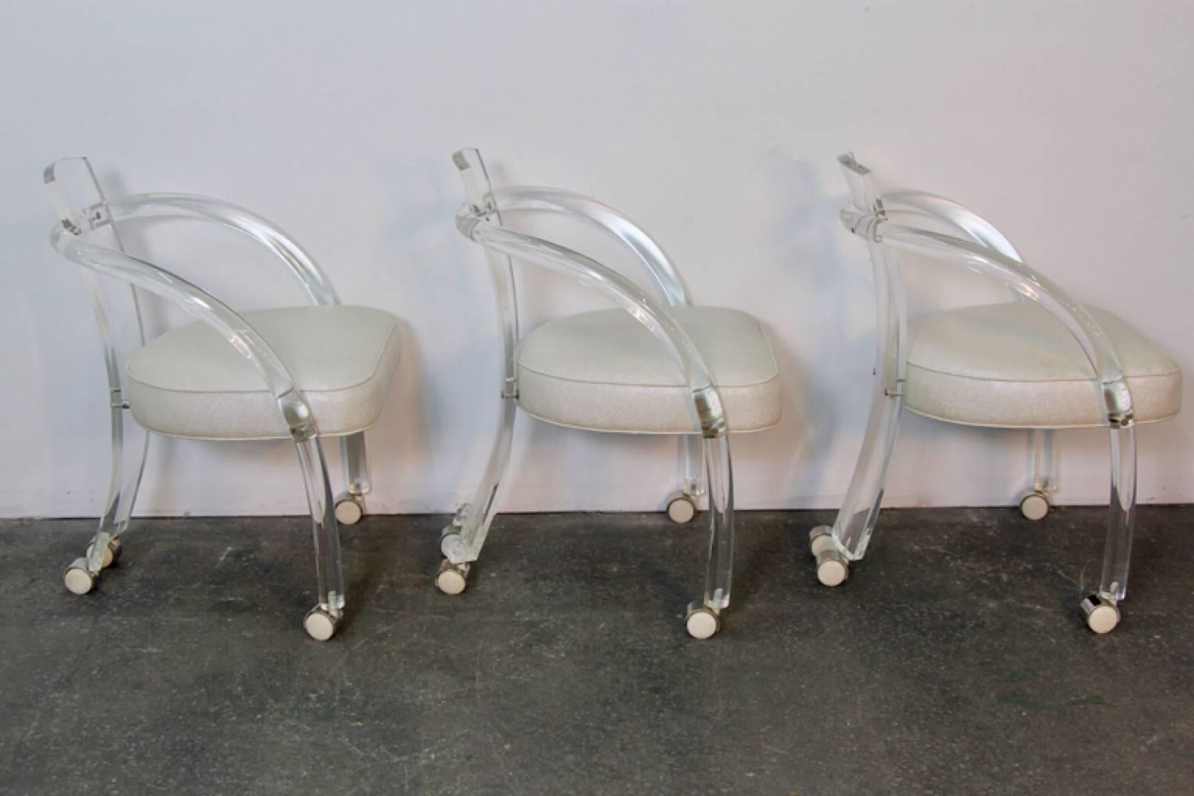 Chic set of six in the style of Charles Hollis Jones, Lucite armchairs. Newly upholstered with faux shagreen, on white castors. Lucite is very clear and in good condition for its age.