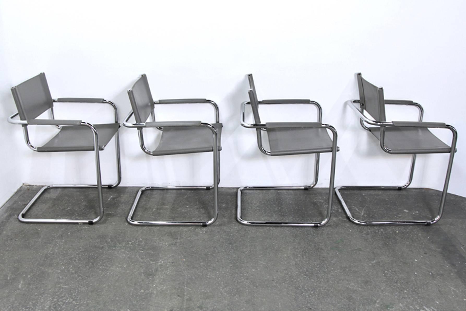 Four Mid-Century Modern chrome and grey leather cantilever armchairs.