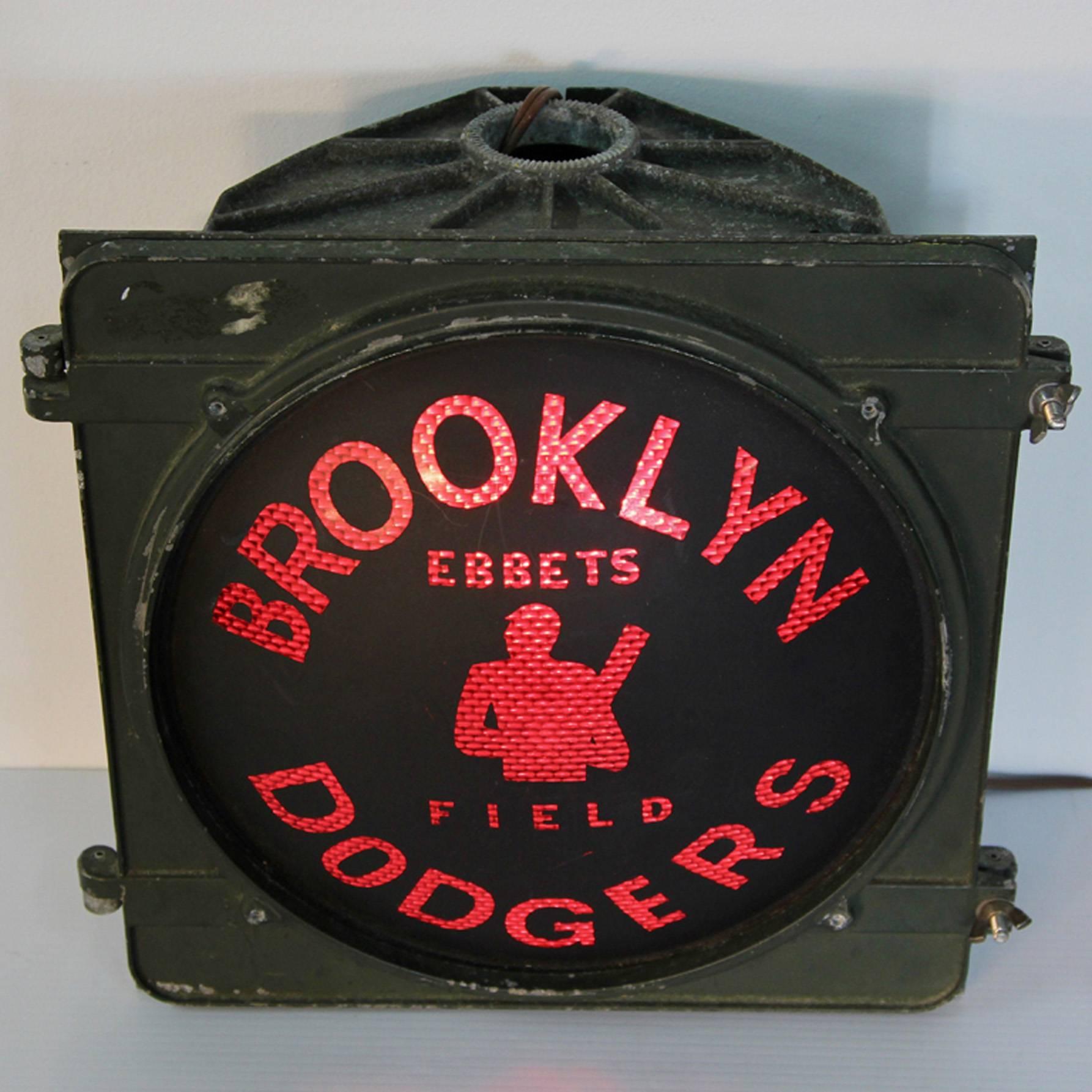 Brooklyn Dodgers industrial stadium light from Ebbets Field. Wired to plug into standard outlet. Curved glass with graphics produces deep red light. Ebbets Field was a major league baseball stadium in the Flatbush section of Brooklyn, New York. It