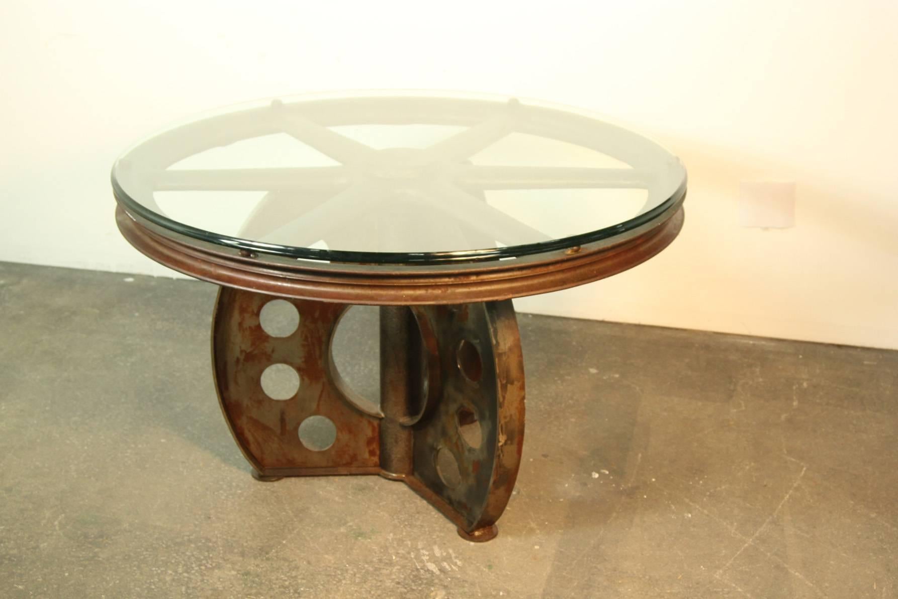 This wheel was rescued from a recycling mill in Manchester New Hampshire.  Originally came from a 19th century New England textile mill.  The base was made from reclaimed metal and was made for the wheel to make this impressive, beautiful dining
