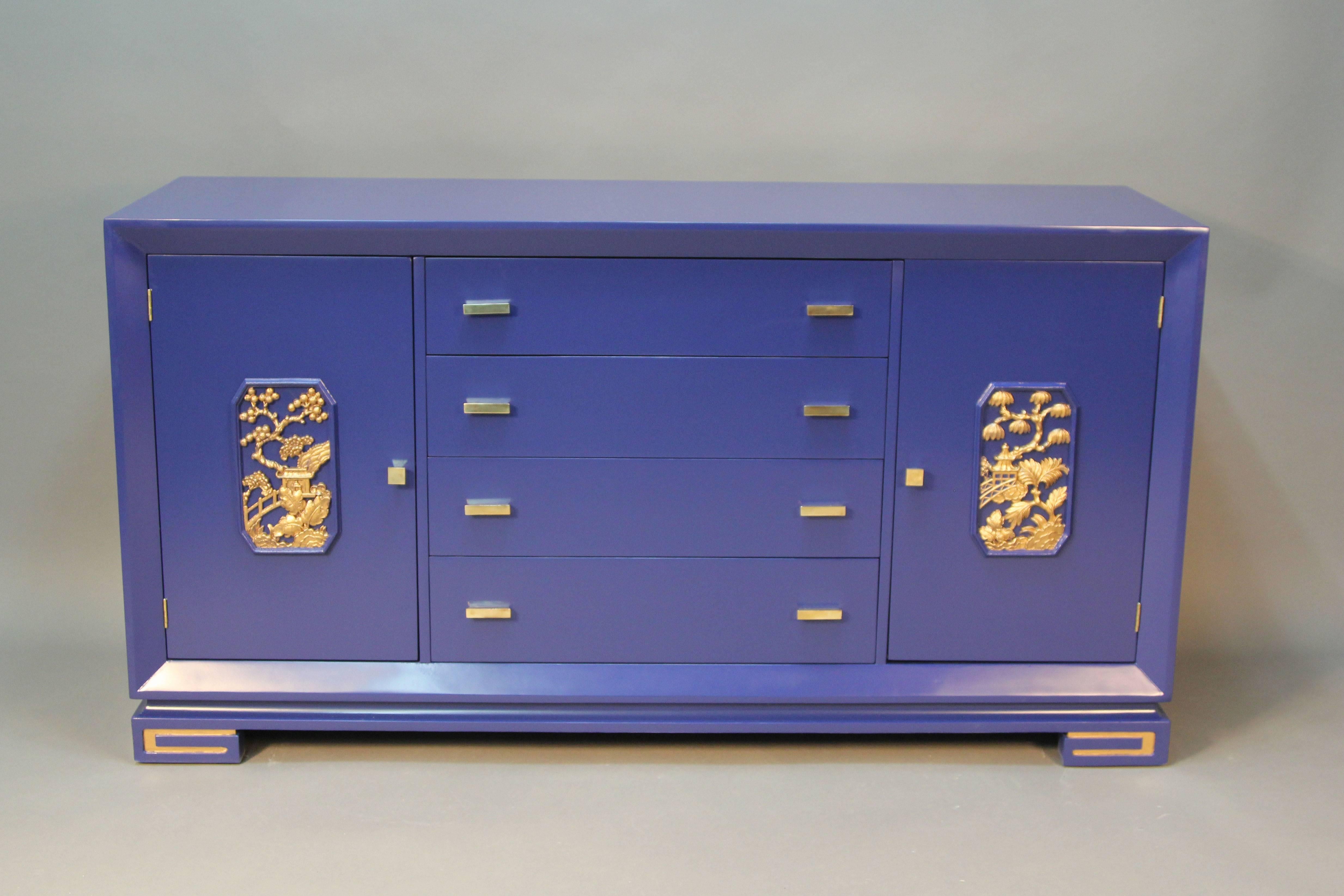 James Mont designed sideboard/credenza. Four drawers and two cabinets with silverware drawers. Newly lacquered in navy blue with gold accent details. Polished brass original hardware.