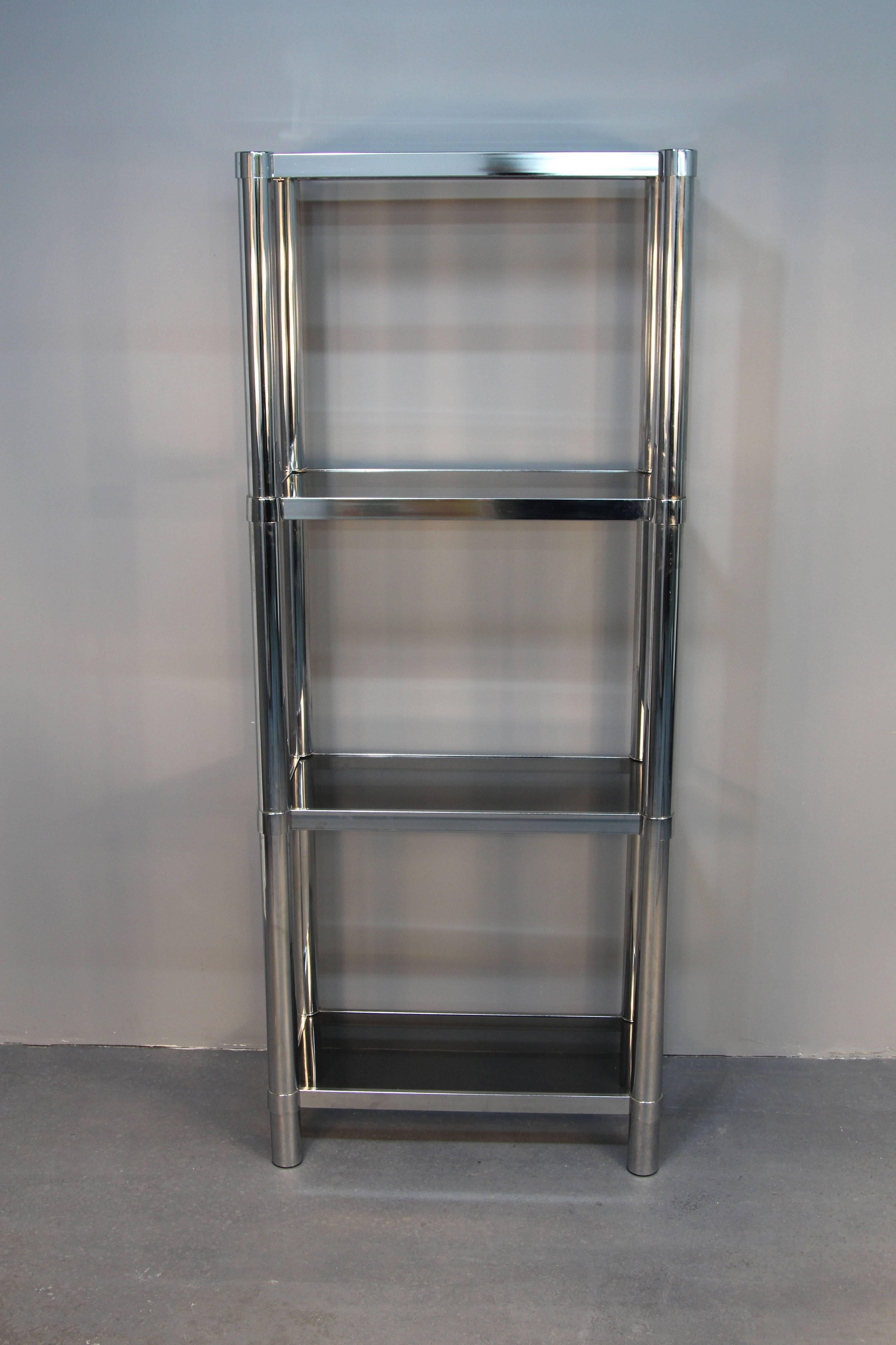 Amazing chrome tubular étagère. Four smoked glass shelves. Sections removable for height adjustment.

Single only, not pair!