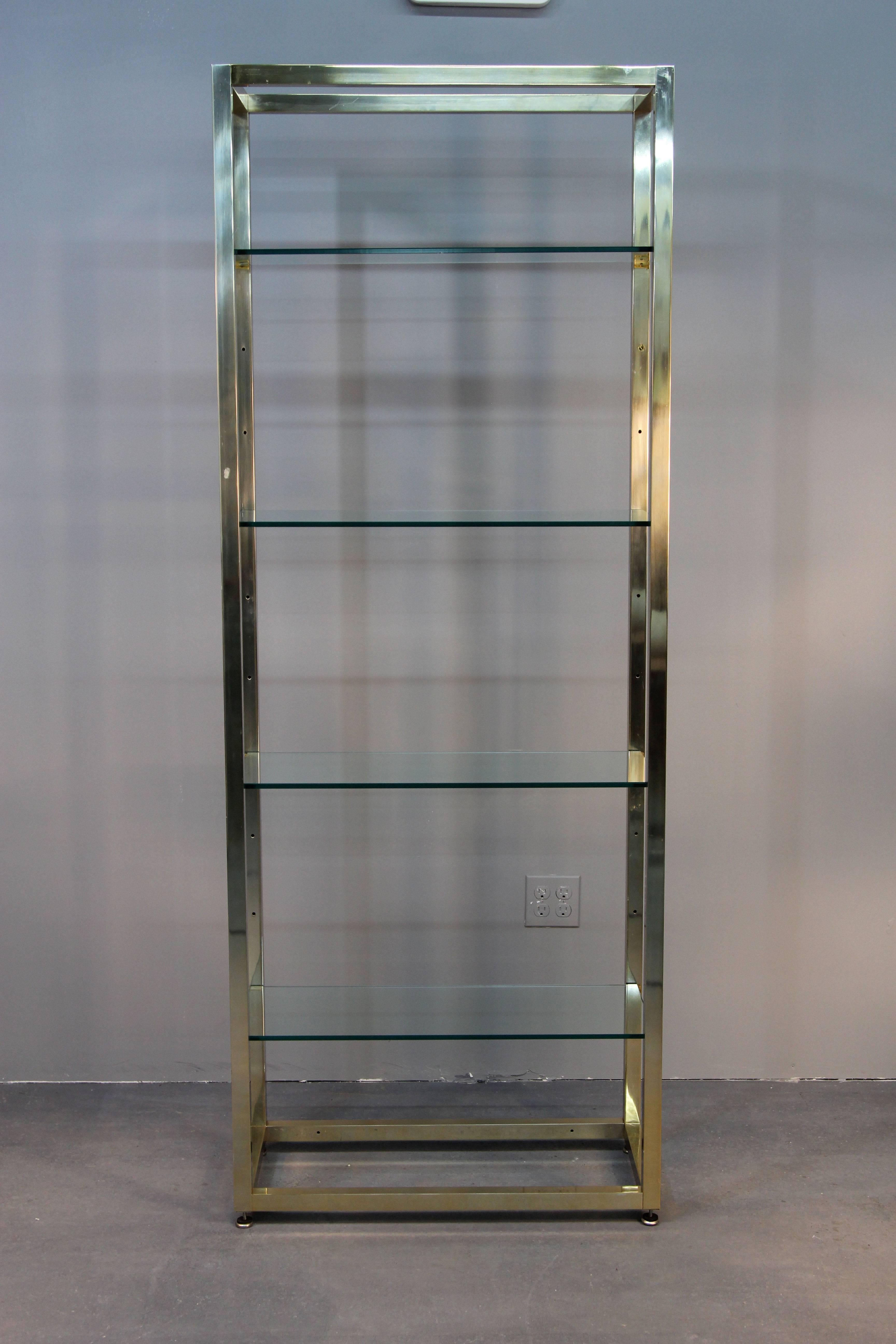 Beautiful modern brass etagere with glass shelves. Clean lines and style.