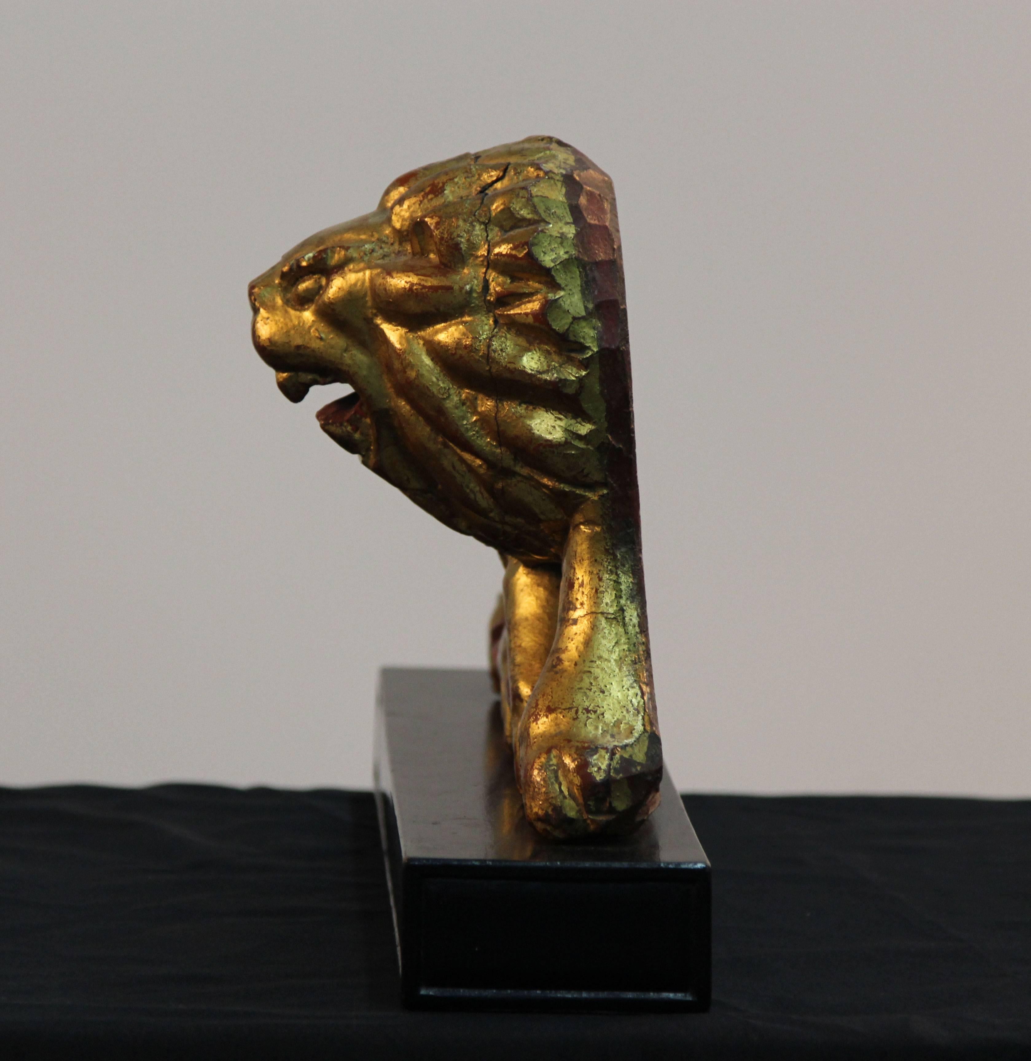 Gold gilded lions on black enamel bases.