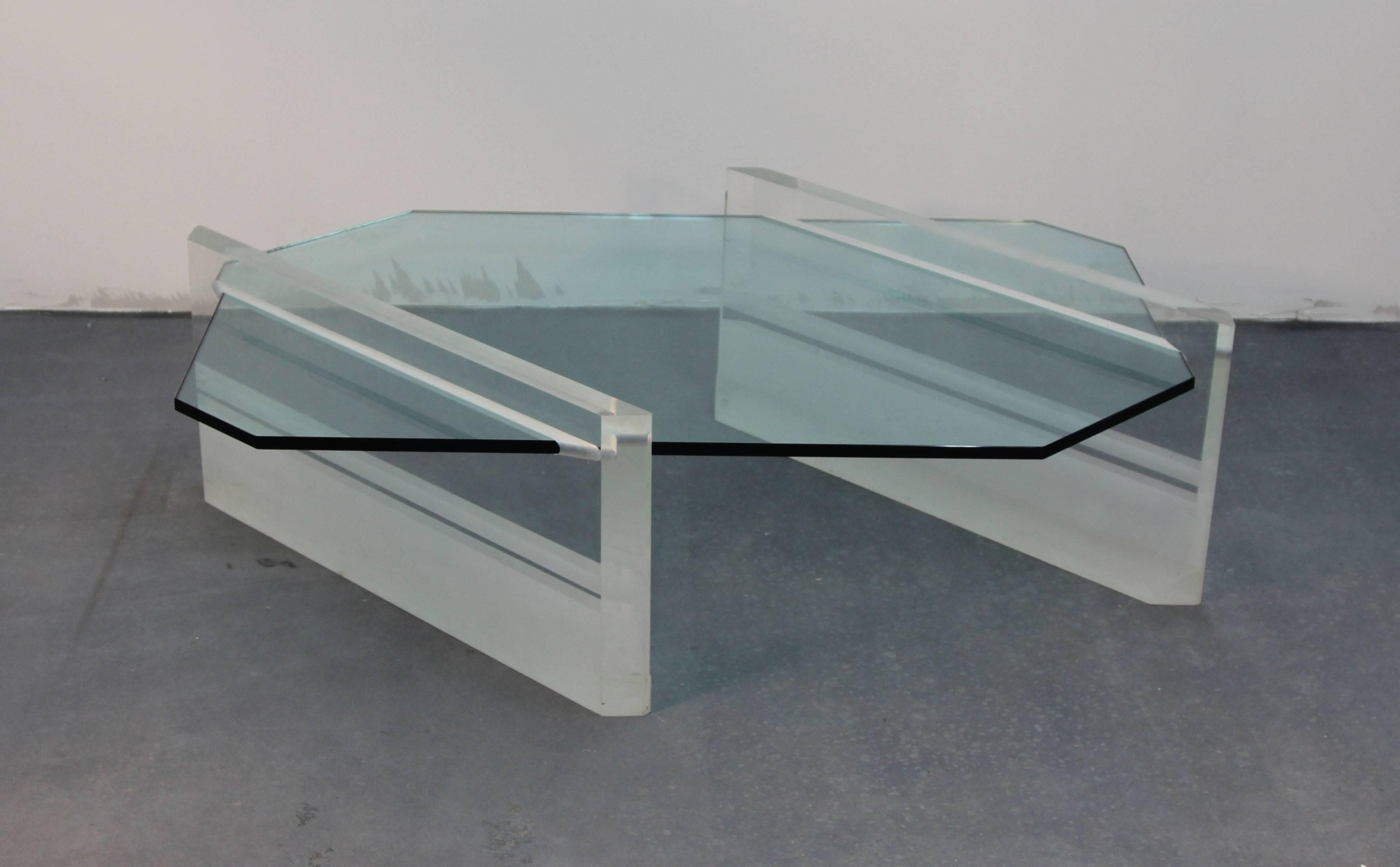 Incredible and very rare glass top coffee table with heavy, 2 inch thick Lucite base. Partially frosted, and partially clear with slits for glass insert. Amazing piece.