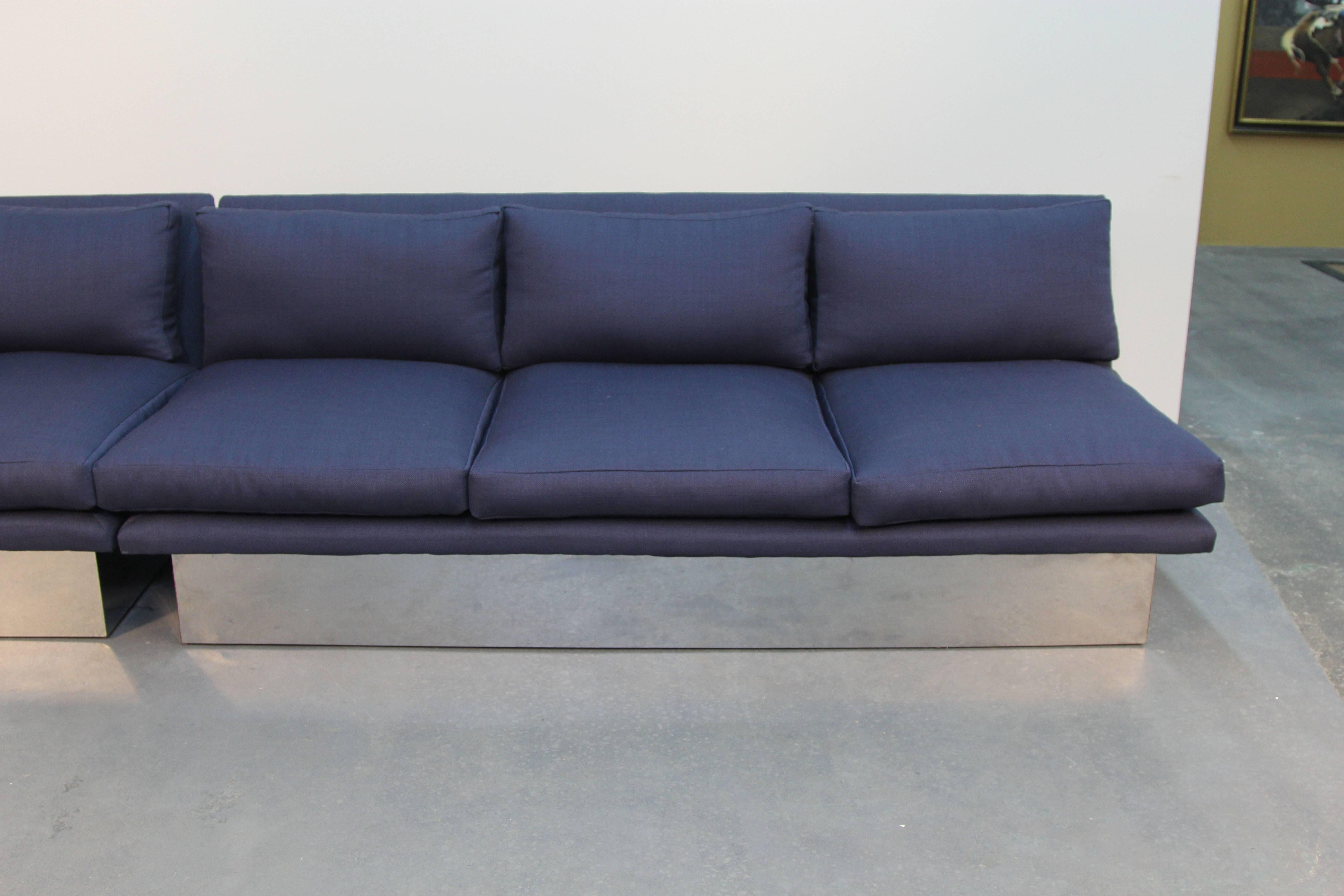 Amazing floating sofa on chrome base. Sofa and chair sectional, newly upholstered in beautiful navy blue textured fabric.