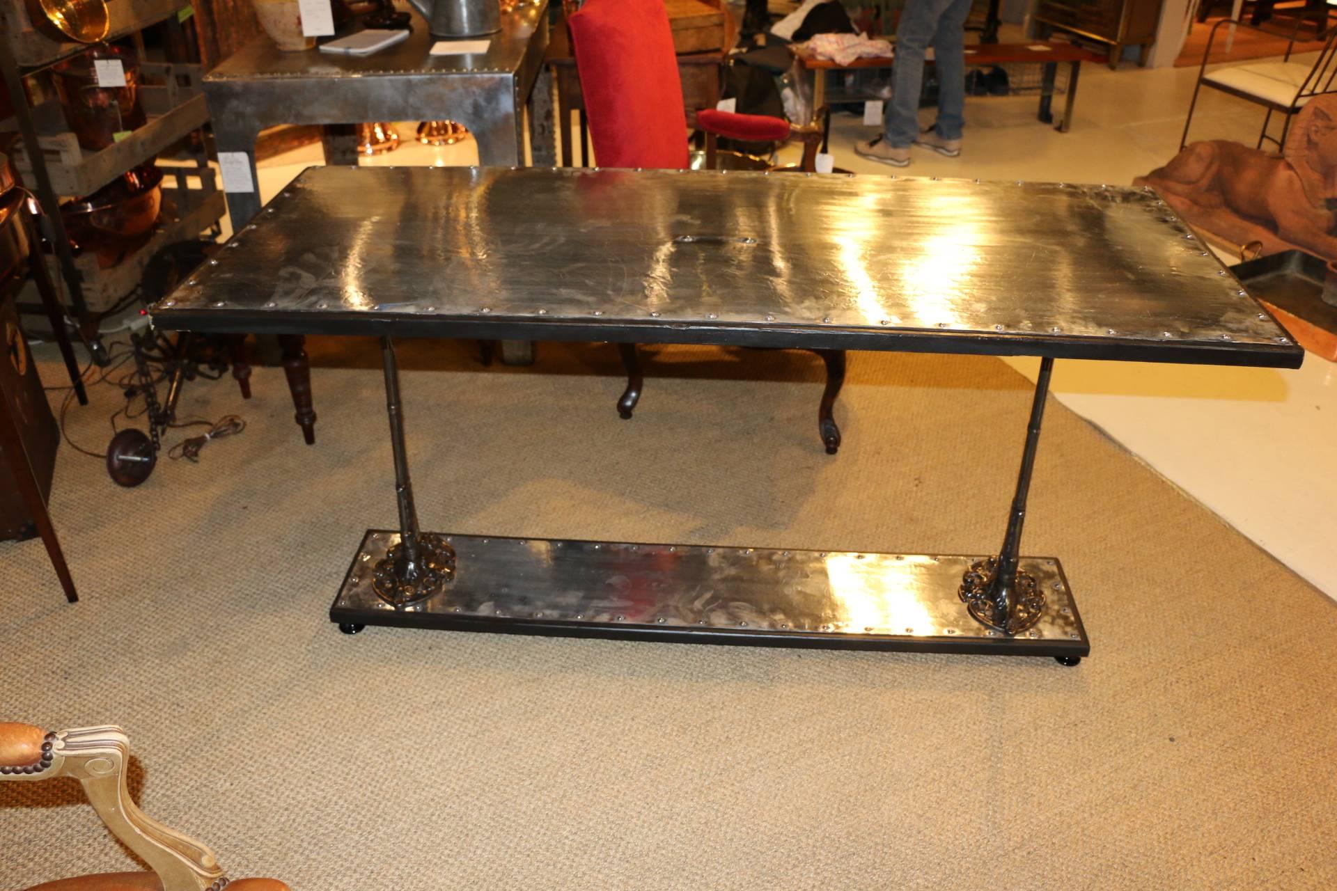 Original French bistro table ends made into a full size table with polished steel top and studding by an English artist. Table ends are from circa 1860.#043-19