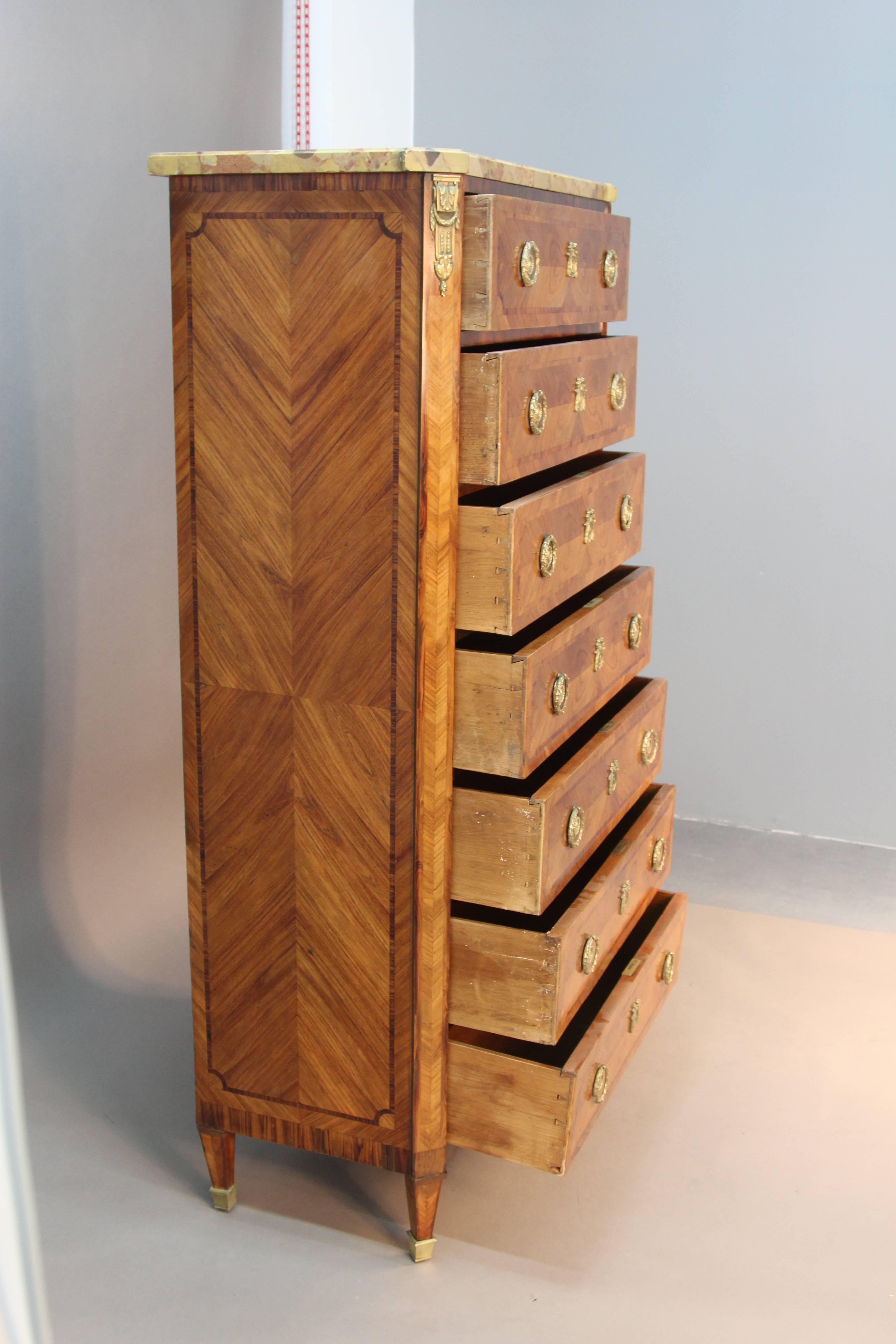 Antique French tall chest circa 1880 with all original hardware and seven drawers. Beautiful marble-top and elegant cast ormolu. Rosewood and kingwood inlay.