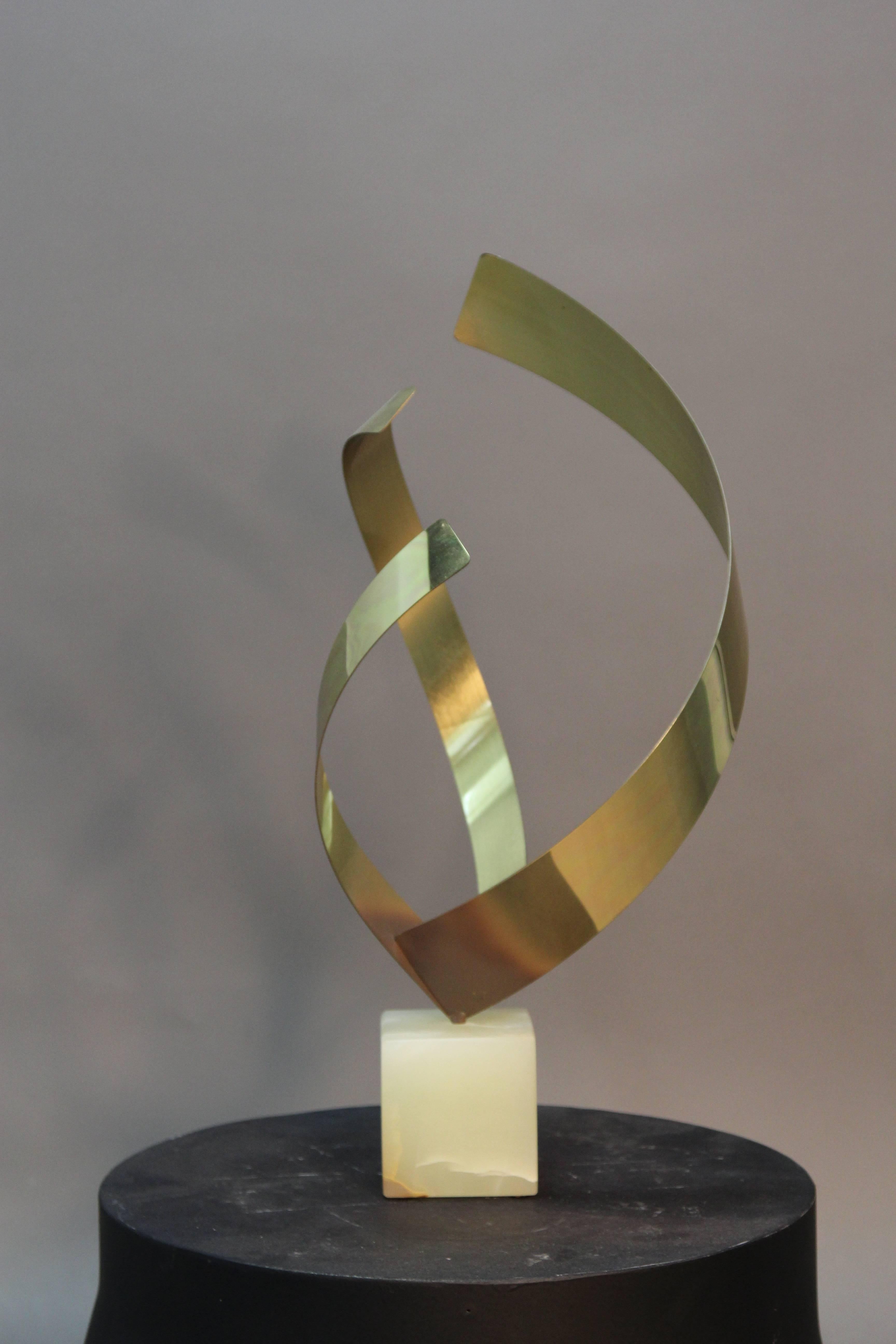 A vintage Curtis Jere brass sculpture of an abstract flame on a 4 inch cube marble base.
