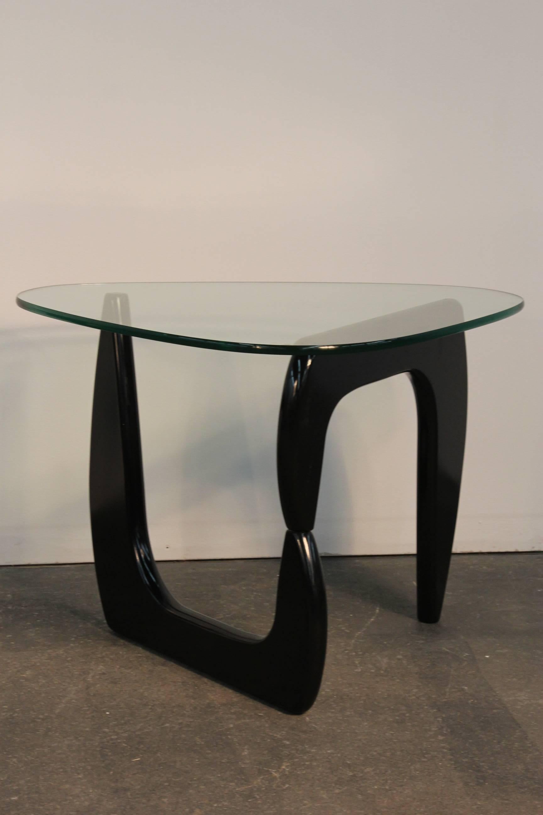 Newly lacquered black expandable bases with triangular glass tops. In the manner of the famous Noguchi coffee table. Great for end tables or nightstands.