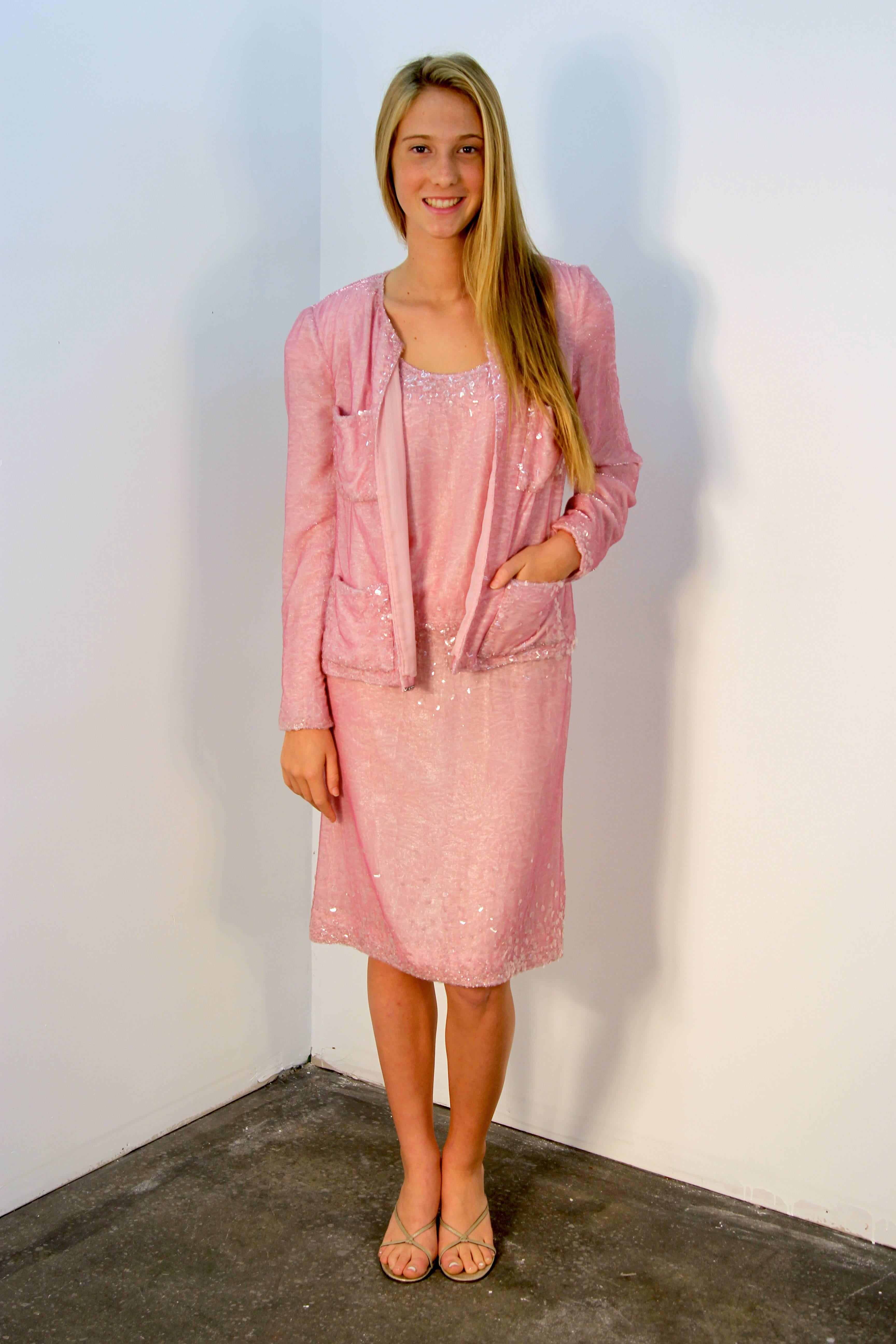 A liquid pink dress and jacket by Chanel, size 42. This unique late 1990s creation has the original price tag of $11,760 still on. The hand-sewn glimmer sequins and luxurious fabric create a liquid Silhouette. Jacket can be paired with jeans as well.