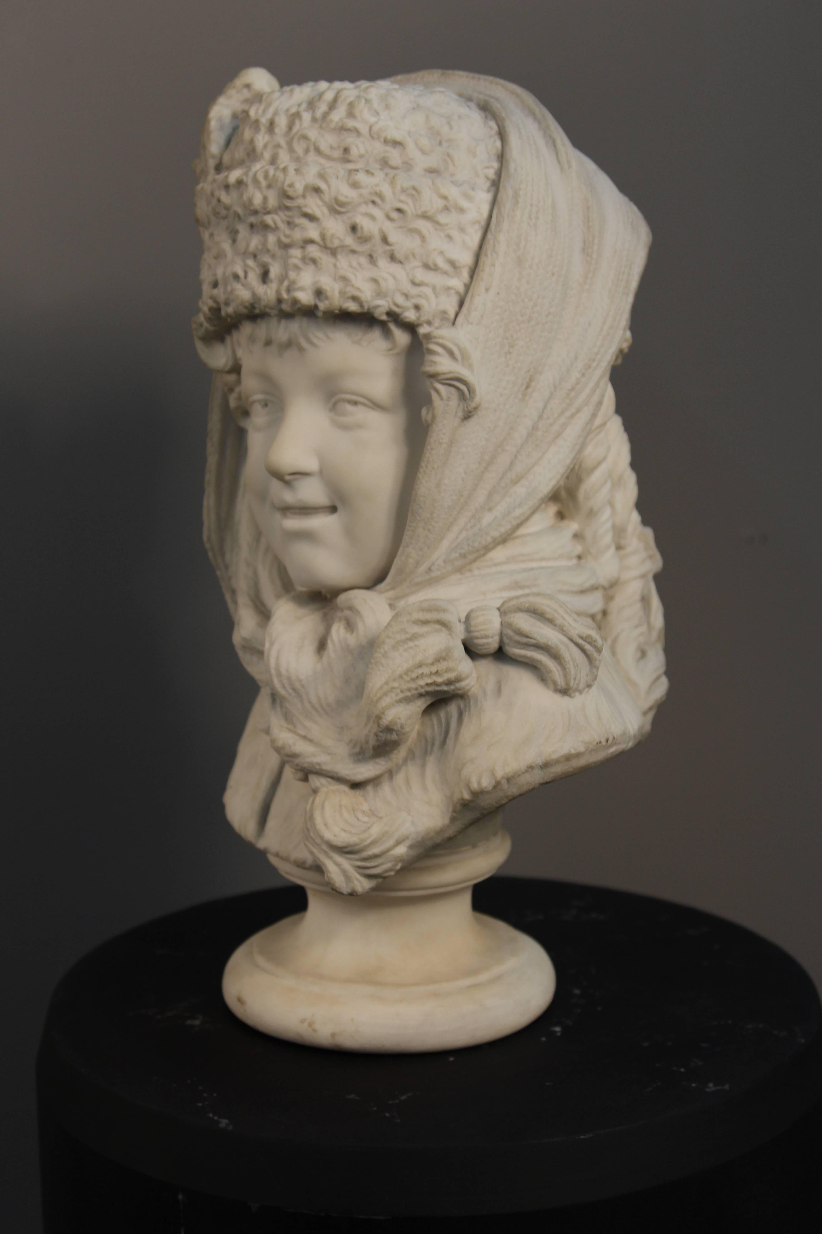 A 19th century carved marble sculpture of a Russian Boy. Having a pretty face with a natural happy expression. In the manner of the youngest and only son of Emperor Nicholas II Feodorovna. Signed with initials carved on back.