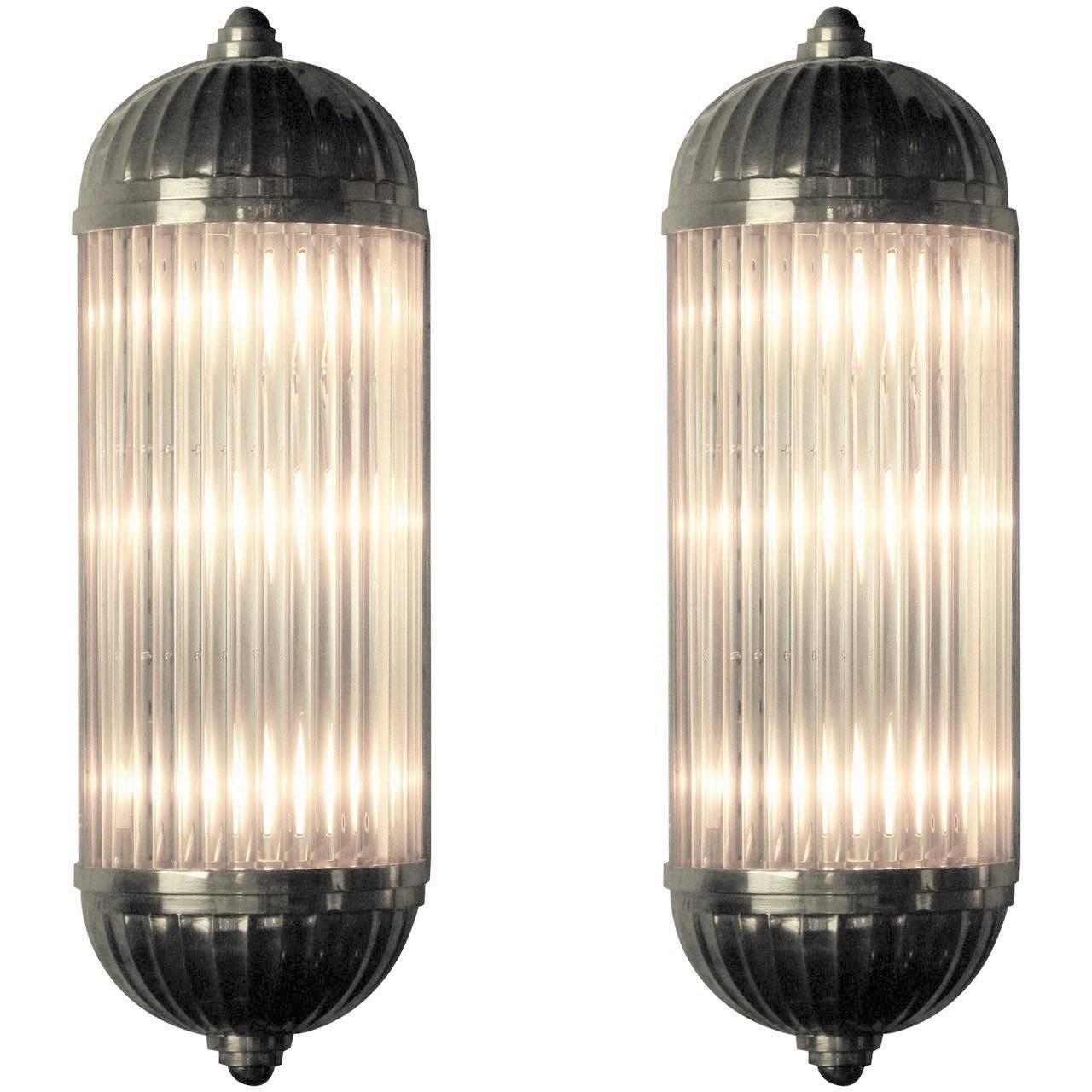 Multiple pairs available. Can be sold individually, price listed is for one single sconce.
French Modernist tubular sconce featuring long solid clear glass tubular rods that form a half cylinder shaped column, mounted in heavily cast polished