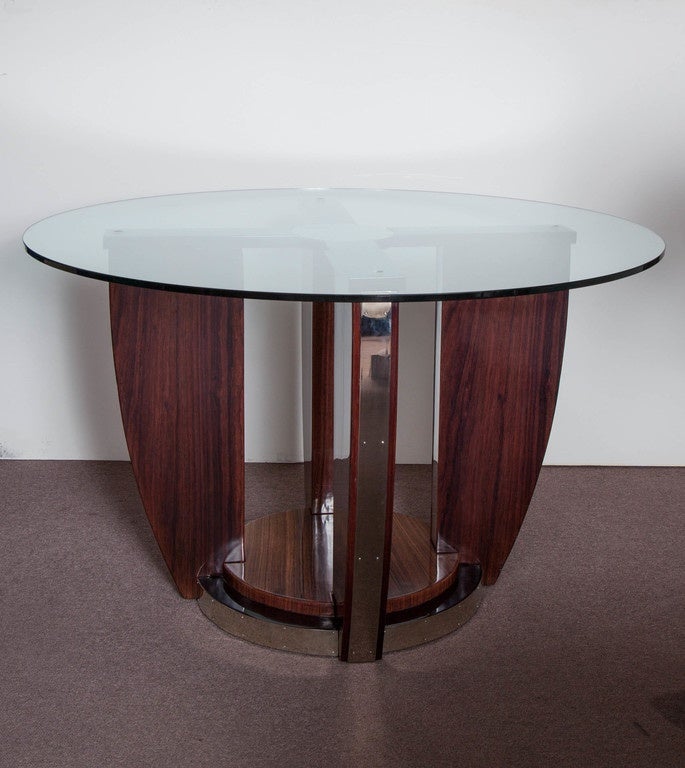 Elegant French Moderne rosewood center table with circular stepped base holding four arc shaped winged sides displaying nickeled bronze mounts and banding.
Attributed to: Louis Sognot (1892-1969/1970.)
This table can easily accommodate a larger