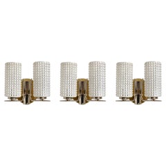 Three vintage 1960's enameled glass, brass & nickel two light wall sconces