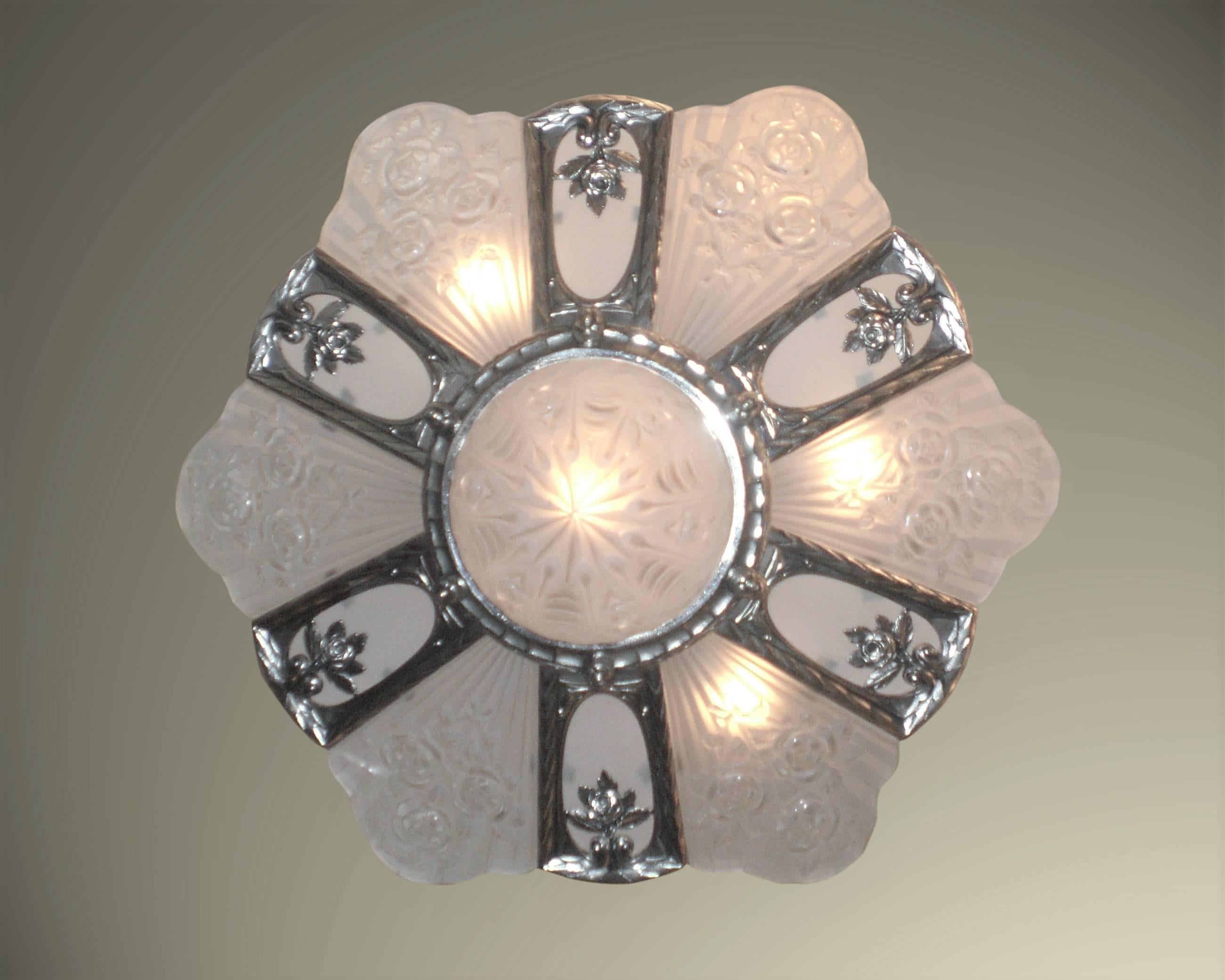 French Art Deco large and important chandelier signed Gilles. Six molded frosted white art glass panels with scalloped tops bearing rose and linen fold detail along with six flat frosted insets and a deep matching central coupe mounted in a fabulous