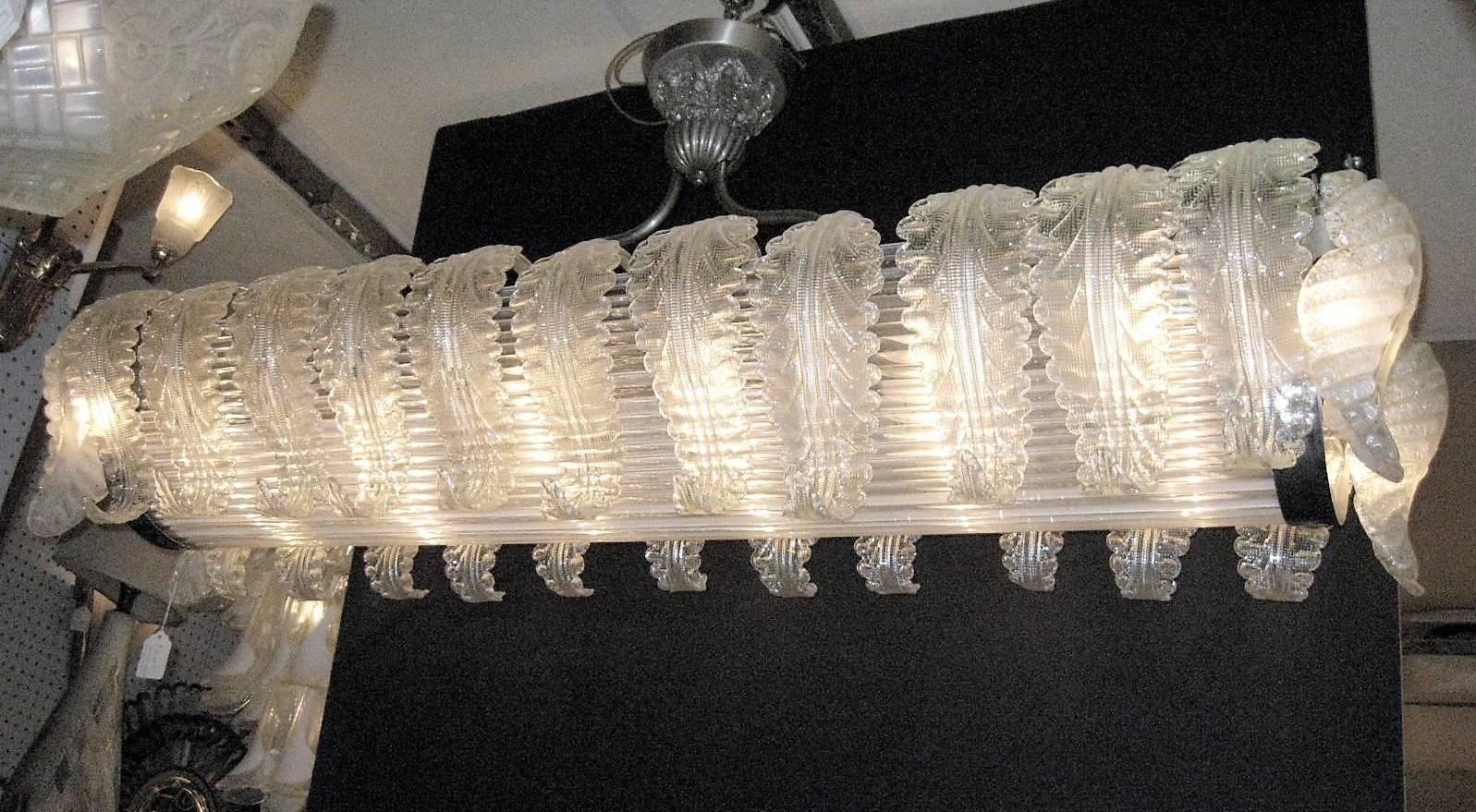 Stunning and rare 26-leaf Venetian glass chandelier with tubular rod centre. A phalanx of individually blown long curled leaves bearing cross hatch Design Line a semi-cylindrical shaped reeded glass rod centre. The original armature in polished