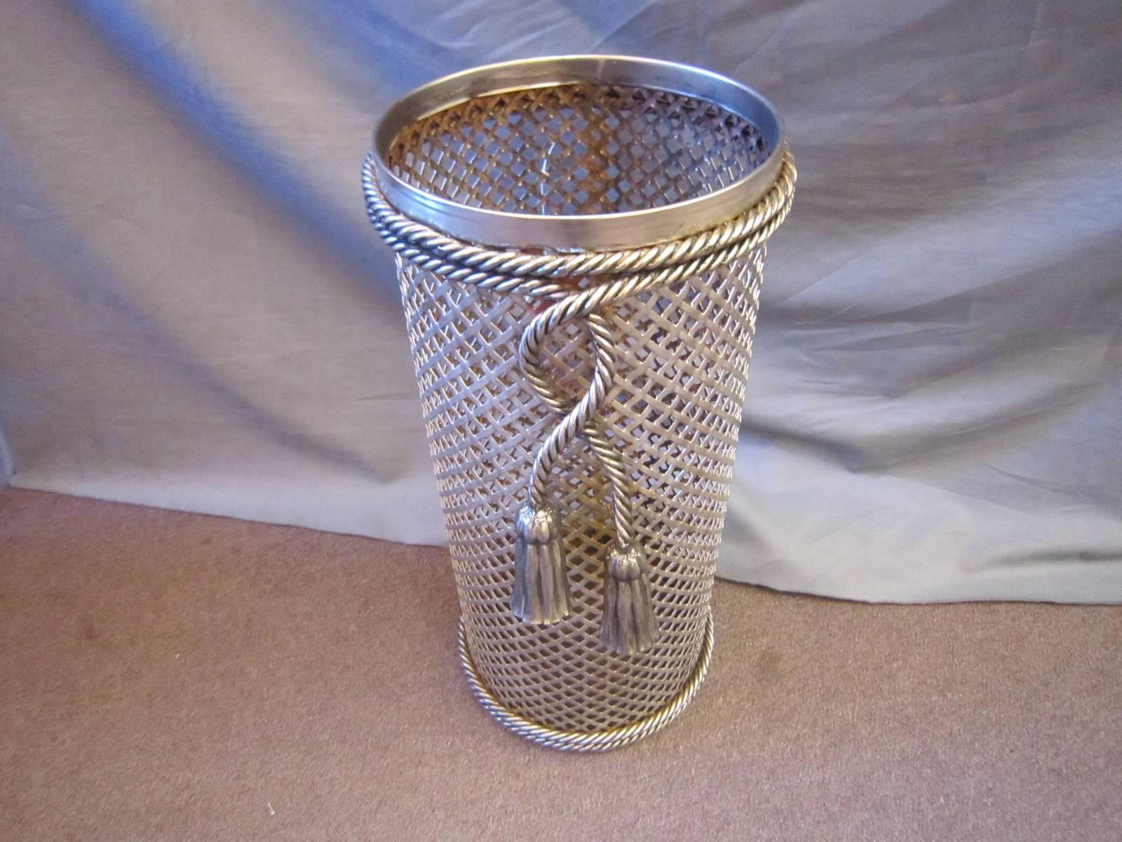 Modernist Italian nickeled iron umbrella or cane stand with perforated woven cage and rope twist tassel decoration. 
Can also be used as a wastebasket in an Industrial or moderne setting.
In fine, beautiful condition, some interior wear