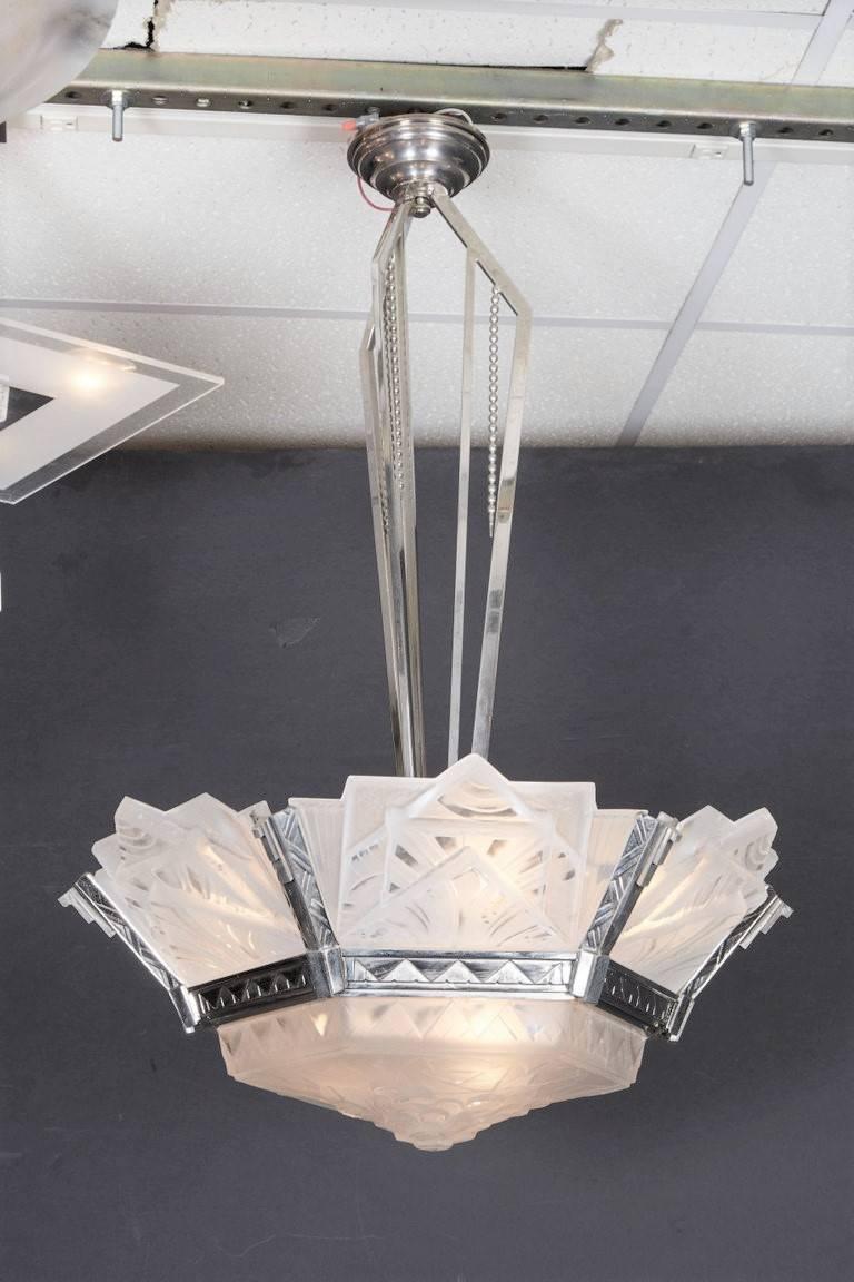 A fine French Modernist chandelier signed Muller Freres Luneville with six angular panels of heavily molded frosted art glass surrounding a matching hexagonal central coup, mounted in original polished nickeled bronze armature with matching