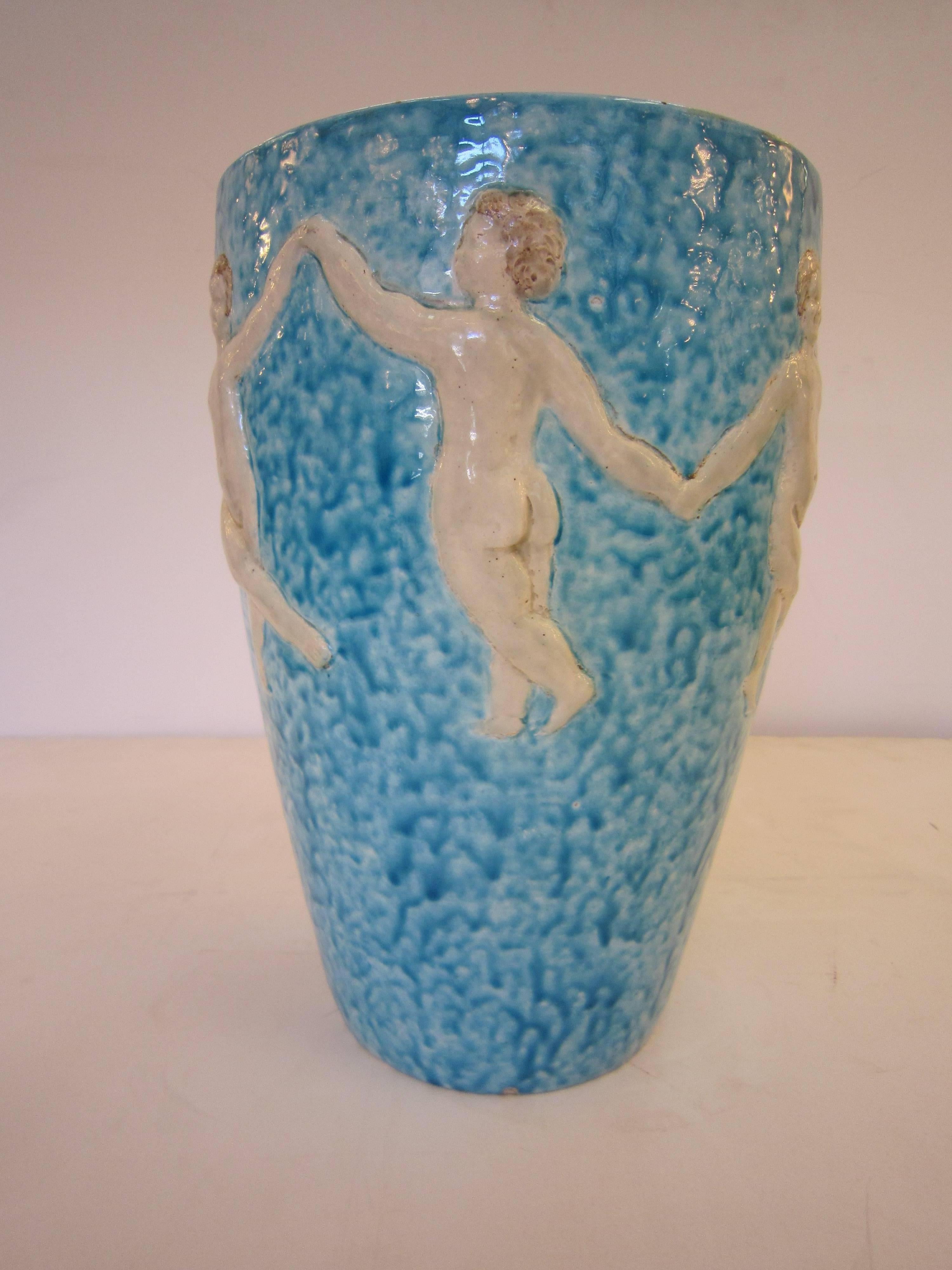 French Modern pottery vase in mottled turquoise and creamy white glaze depicting children dancing and frolicking while holding hands.
Fine details overall with sculptural bas-relief effect. Ceramic, longwy, Boch freres.
Signed: R. Maynard.
  