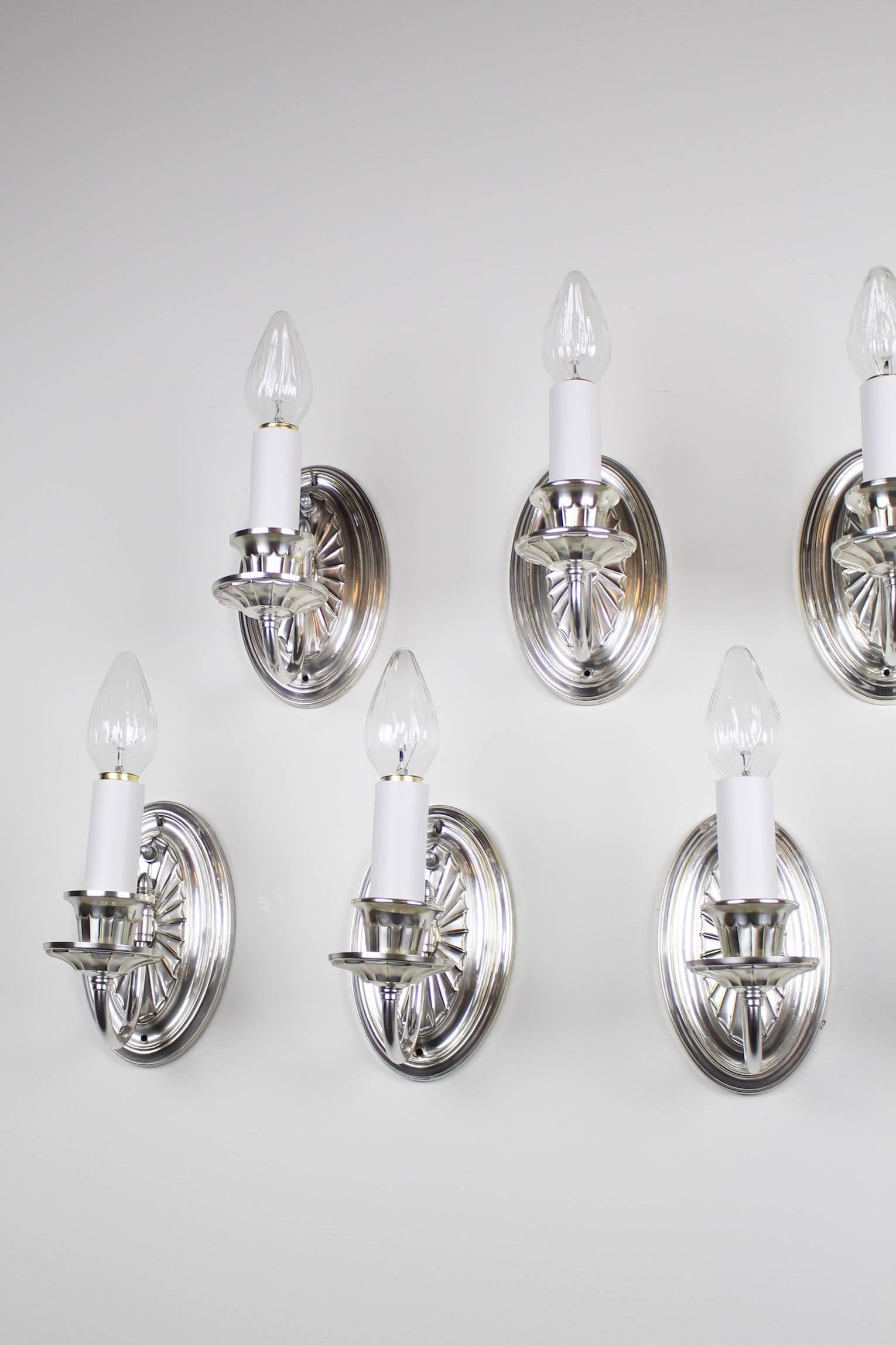 This is a group of nine wonderful original "Adam Style" wall sconces, circa 1923. With a restored silver plate finish and new wiring, they are ready to hand. There is a set of eight (matching) and one (very sightly) odd duck see group