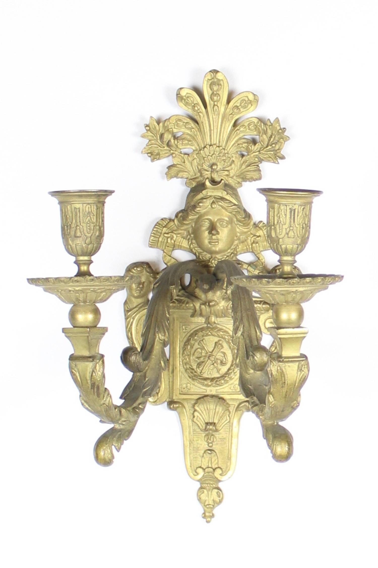 An absolutely superb pair of double-arm figural sconces done in the Beaux-Arts style just after the turn-of-the century, circa 1910. Depicting a central female figure surrounded by grand decorative motifs. Each sconce has two candle arms. These