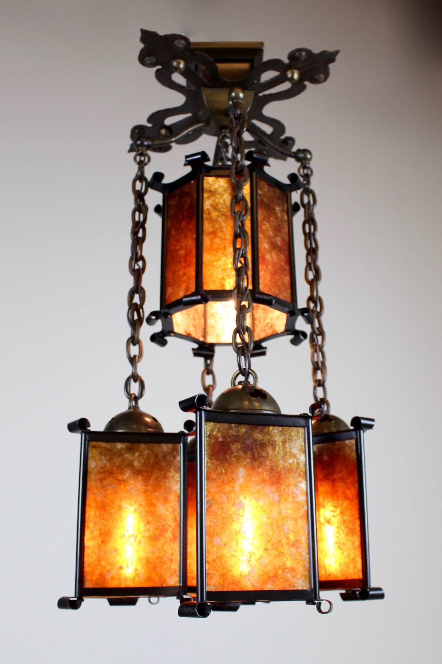 This is a superior flush mount light fixture in the Stickley or California Craftsman style, circa 1910. Featuring curled brass corner edges and cut-out details. It has been fitted with mica for a period correct warm amber glow. This five light