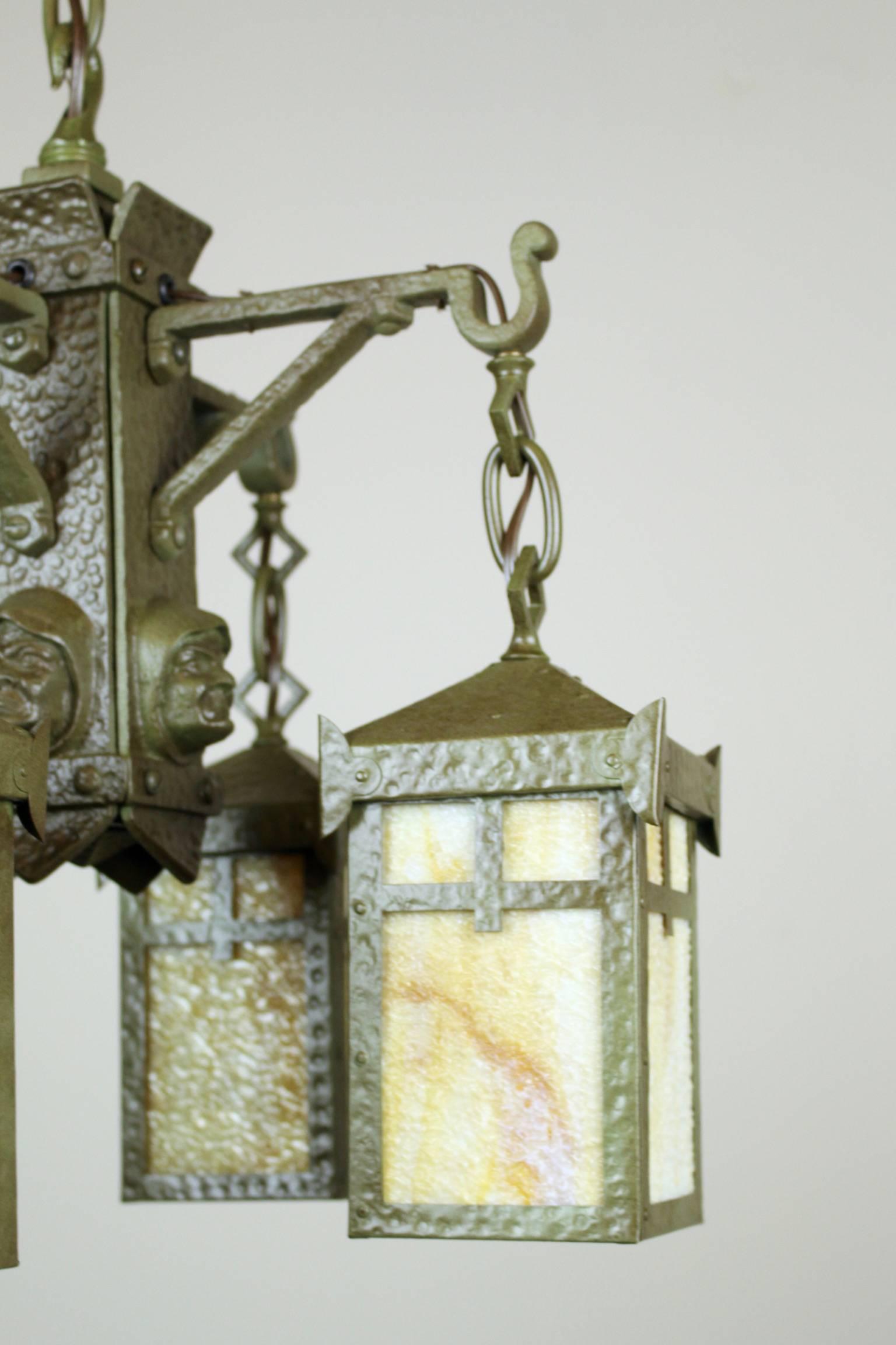 Circa 1906 Arts & Crafts four-light ‘Monk’ fixture attributed to Bradley & Hubbard.

Predominantly hand made with hammered cast iron body and lantern shades. An unusual design embodied in the original ‘Verdigris’ finish and fitted with period