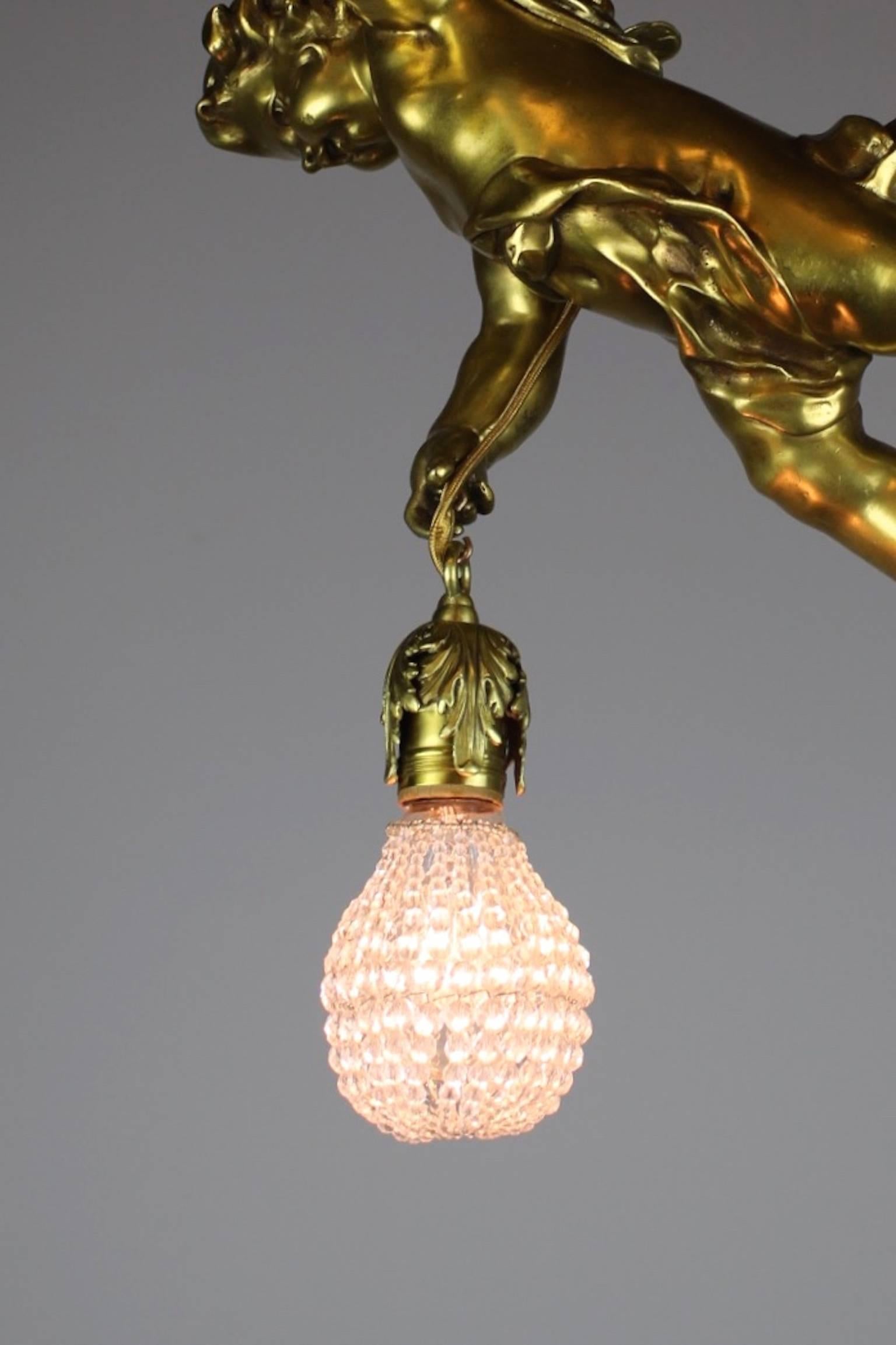A quality fixture in the Renaissance Revival style, circa 1915. The body of a cherub flying through the air makes up this antique light, cherub dangles the light delicately in his hand. The bulb has been fitted with a beaded crystal sock.
Makes for