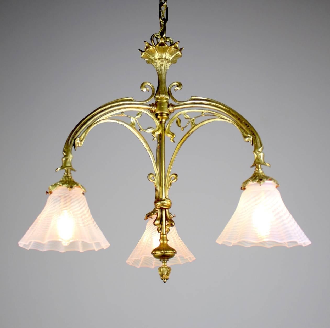 Gorgeous three-light Art Nouveau fixture.

Original ormolu finish with Gothic design overtones.

Fitted with three French twist opalescent art glass shades.

A very beautiful, all original piece.

Measures: 40