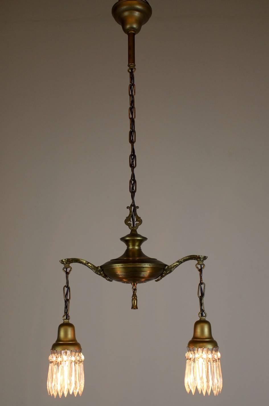 Charming little two-light pan fixture, in the Colonial Revival style.
Fitted with prisms and finished in lacquered old brass color, 
circa 1925
Measures: 41
