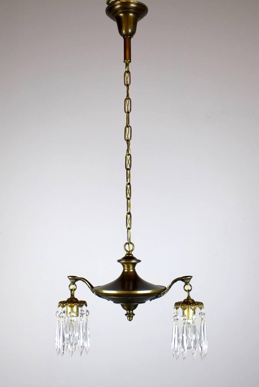 Dainty two-light pan fixture.

Finished in dark antique brass with polished highlights and fitted with crystals,

circa 1915

Measure: 41