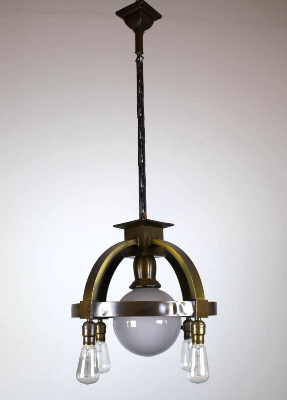 Sturdy Industrial style commercial fixture.

Finished in a dark olive bronze color.

Bare bulbs on the ring increase the Industrial aspects of this light, softened down by the centre glass globe shade.

Some historic creasing to ring (visible