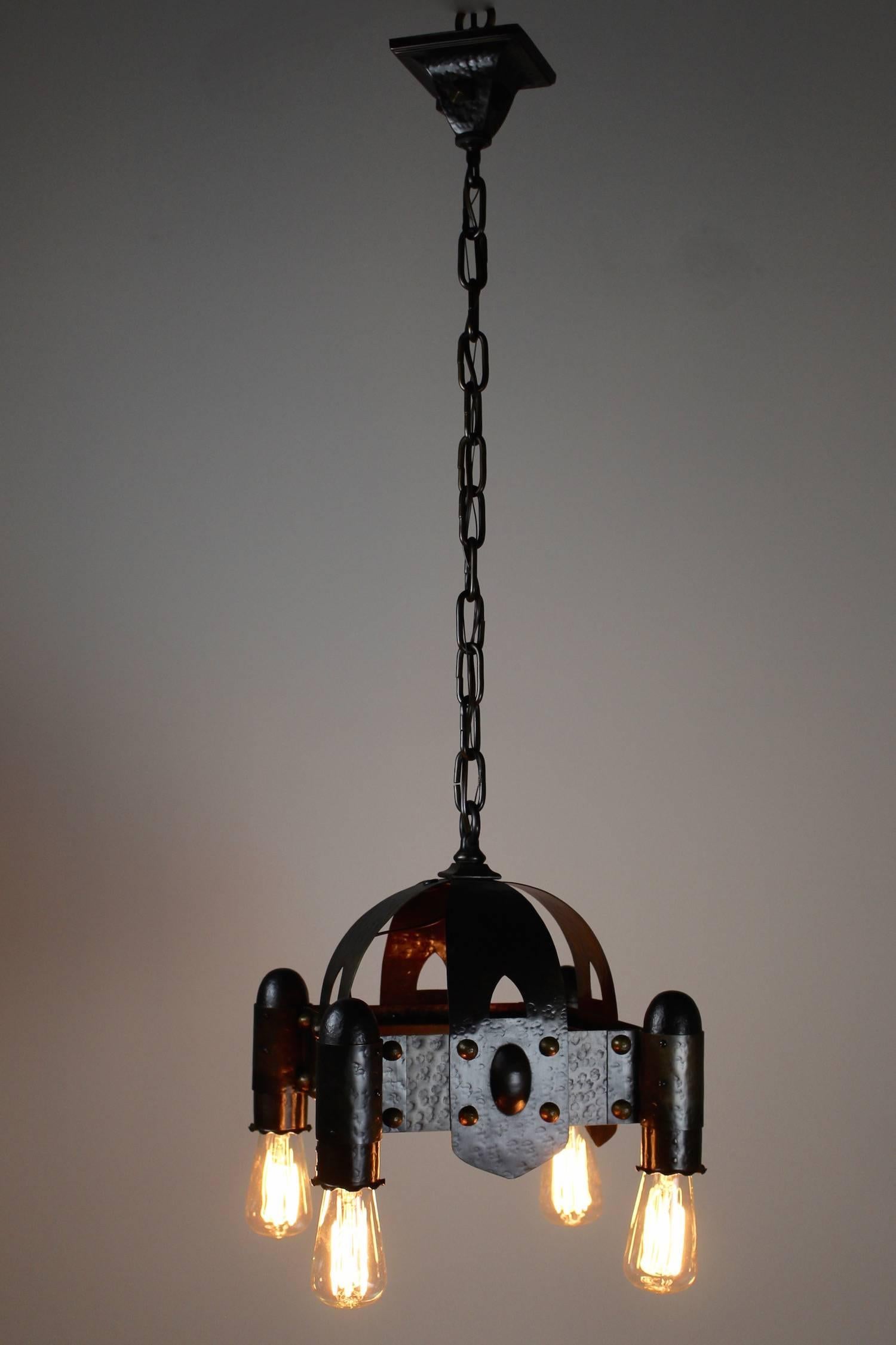 Circa 1912 Hammered Brass Arts & Crafts fixture. Hand hammered and nice 'stud' detail. This light was sourced from a heritage home in in Vancouver, BC. Rewired, restored, and ready to hang. Fitted with four tungsten bulbs (not
