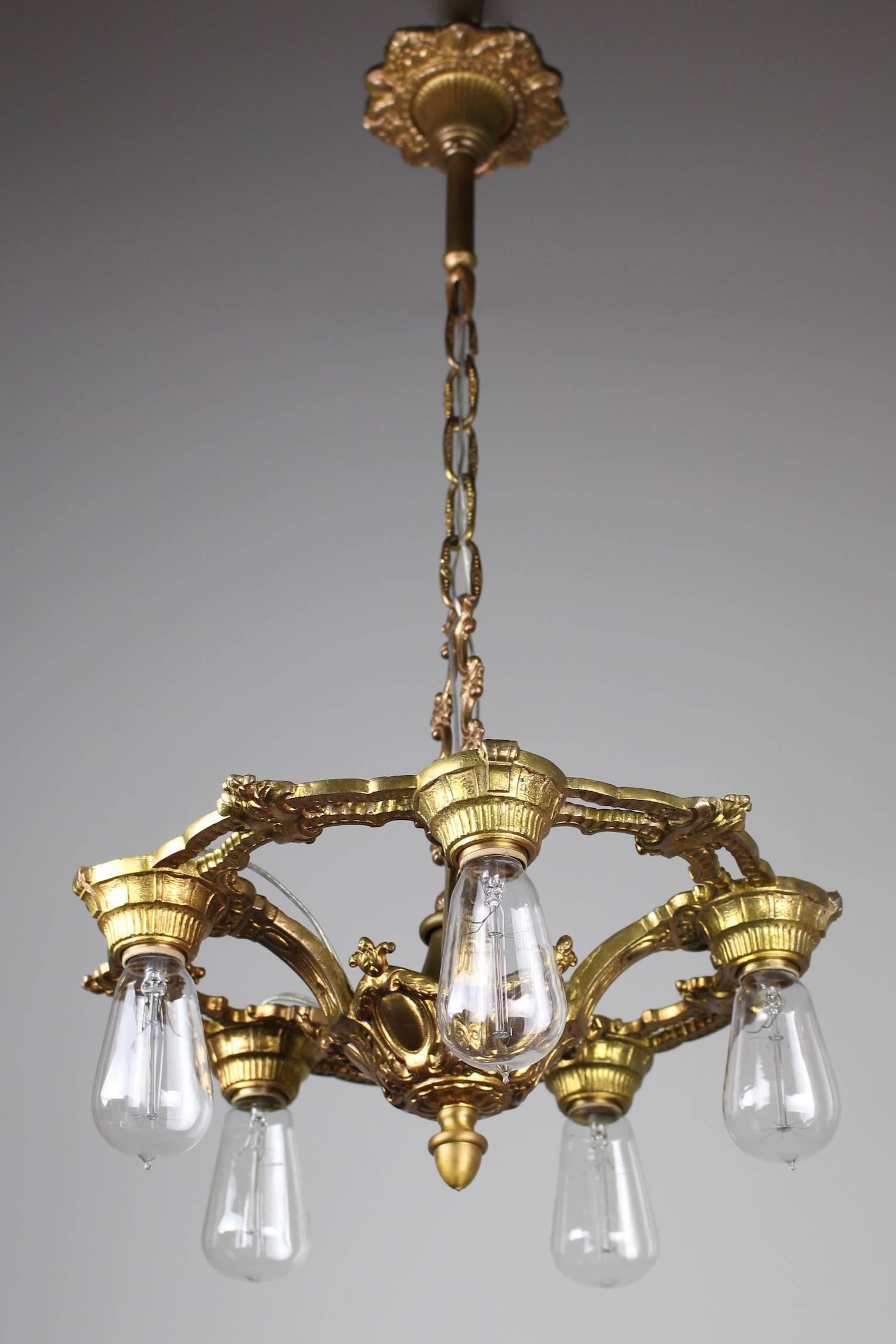 Circa. 1920 This is a lovely cast brass dining room light fixture done in the neoclassical style. Perfectly suitable to 