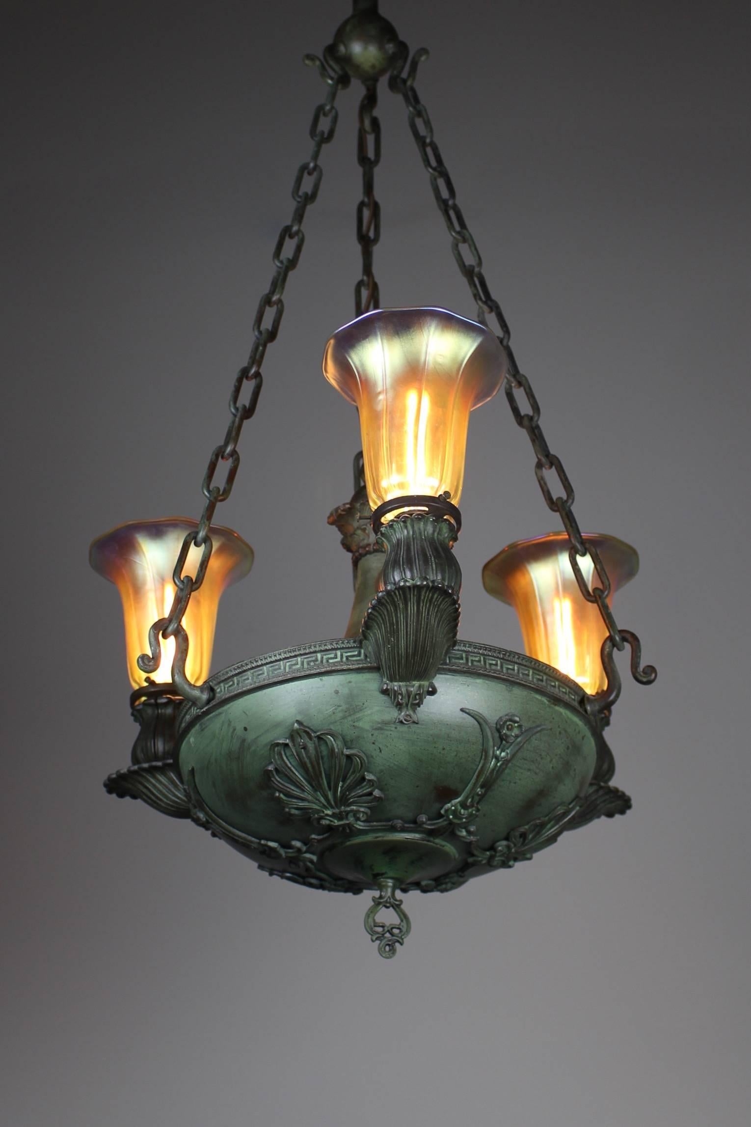 Quite a fine fixture made by Beardslee of Chicago, circa 1905. This three-arm sanctuary light was done in the style of Greek Revival and wears art glass aurene shades. This light has been rewired and restores to its original verdigris finish. Ready
