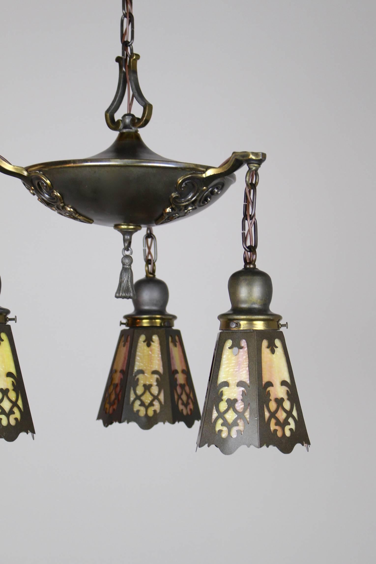 This is a lovely classical revival Tudor pan fixture, circa 1920. All original parts and original finish. Outfitted with 'cut-out' shades. Fixture attributed to Pettingell Andrews. Rewired, restored and ready to hang. SKU DF1256.

Measurements: