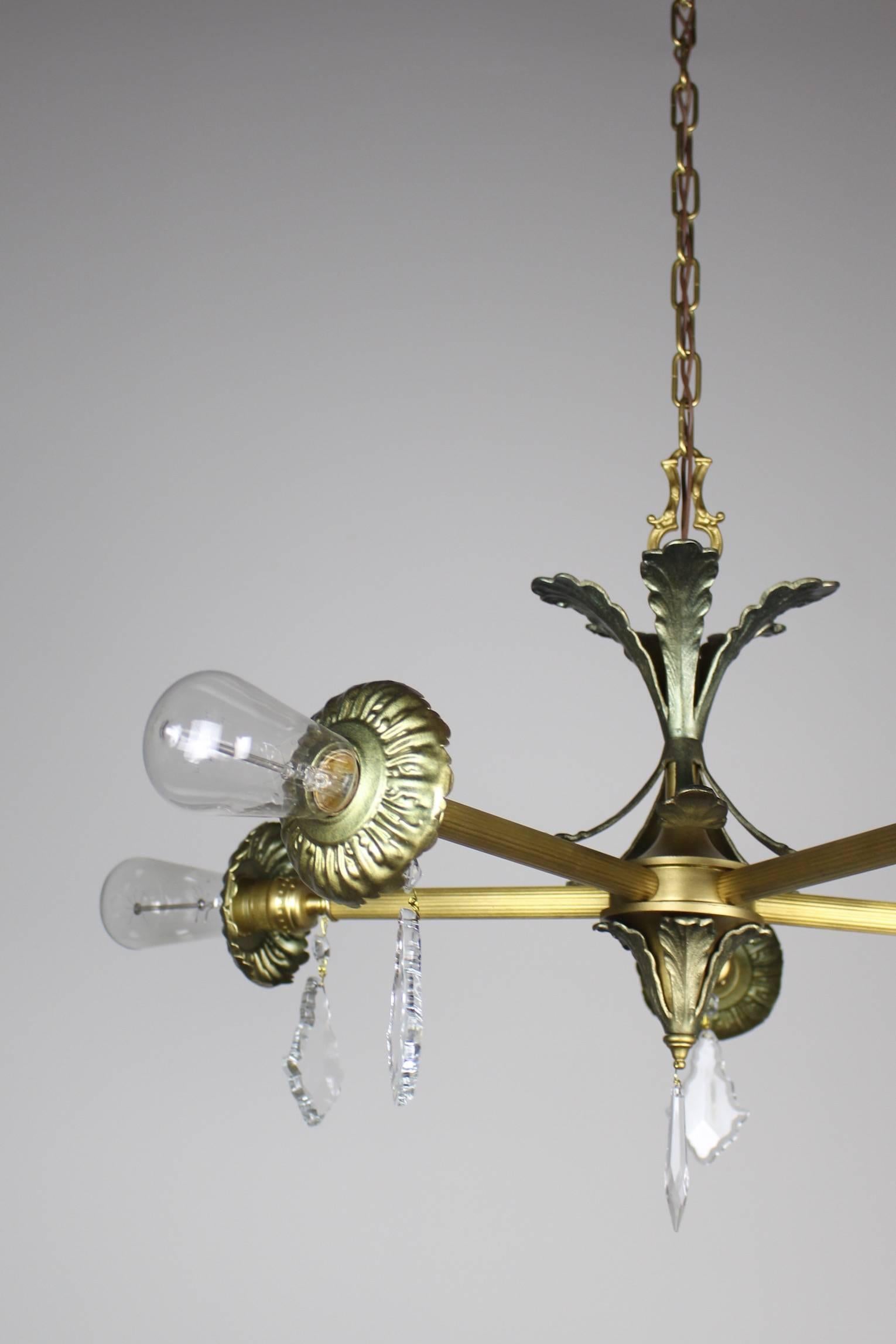 Industrial Steampunk inspired fixture. Five arms, each bearing an Edison bulb - fitted with violin crystals. SKU DF1252 Measurements: 42" L x 30" D,
(28" Min. length).

 