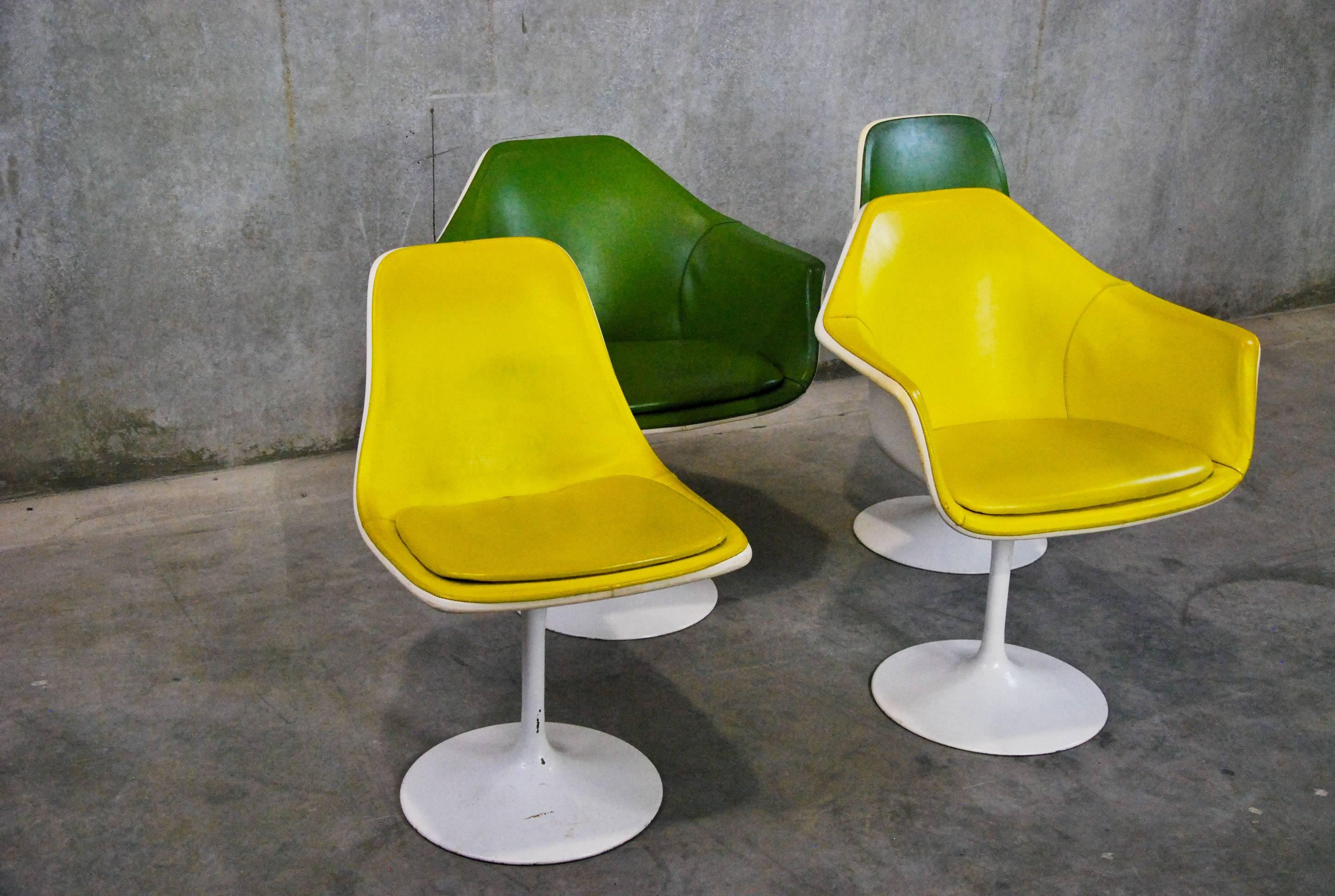 Inspired by Saarinen’s Tulip design, these vintage chairs from Montreal are sought after by collectors for their cool retro look. A co-ordinated set of two tub chairs and two armless chairs, with white fiberglass bodies, metal swivel pedestal bases,