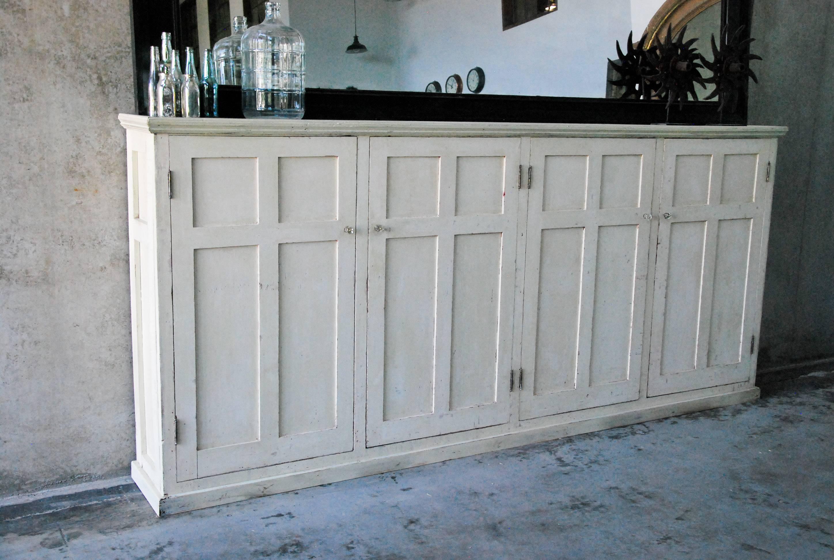 This four-door unit is built of heavy fir with multi-panel doors and sides.
The interior is set up with multiple adjustable shelves. The existing finish is an old cream/white over original varnish.
Found in a warehouse in Pacific North West.