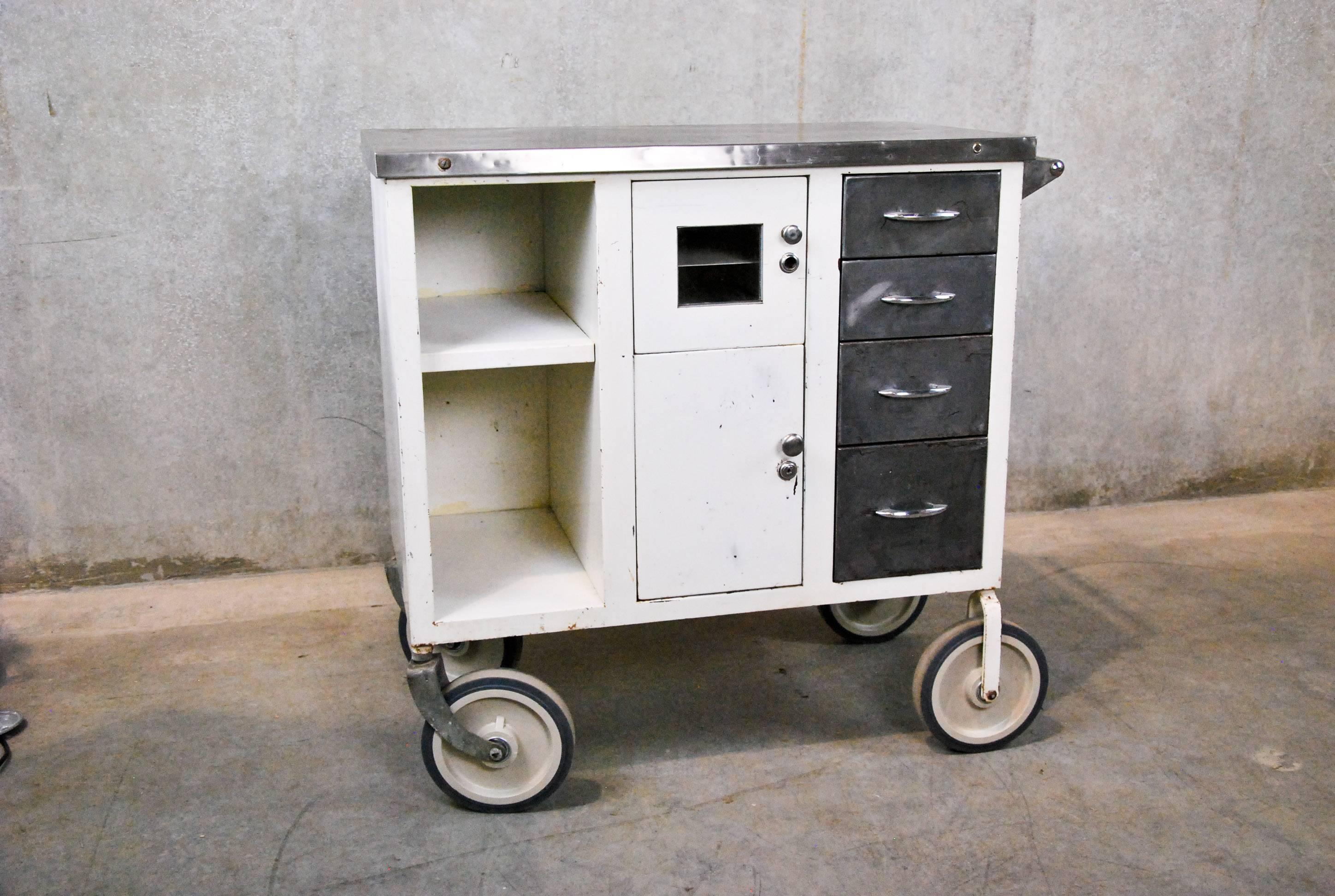 This 1920s-era metal industrial cart was found in a factory near Seattle. It features a stainless steel top and cushioned wheels, suggesting that it was likely a medical cart at some point. Today, its functional drawers, doors, and compartments