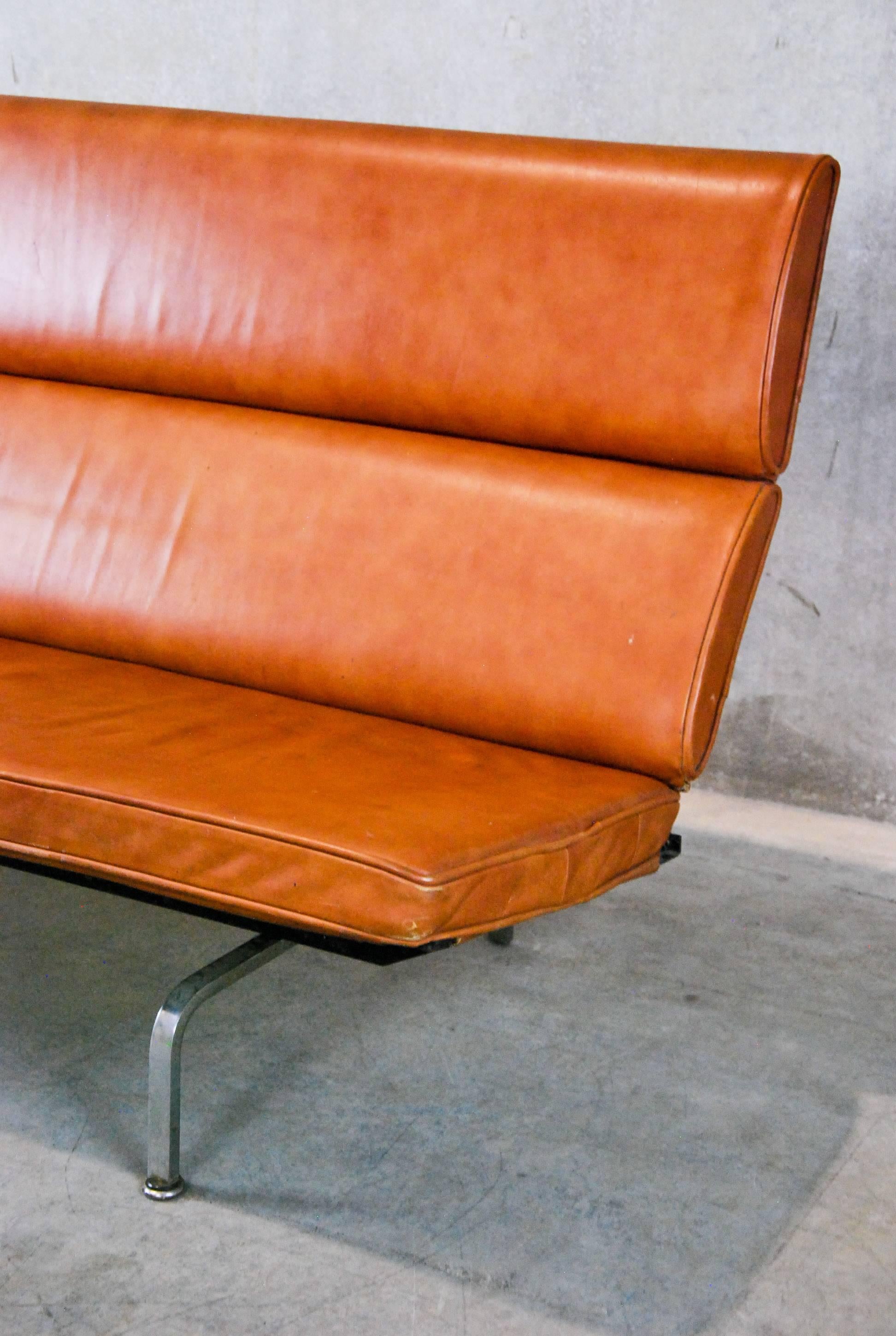 Designed by Charles and Ray Eames in the 1940s, this leather and chrome, fold-down version of the Compact Sofa was made by Herman Miller in 1958. It has its original, anti-sag springs. Sourced from a private collection in Seattle. 

The Eames sofa