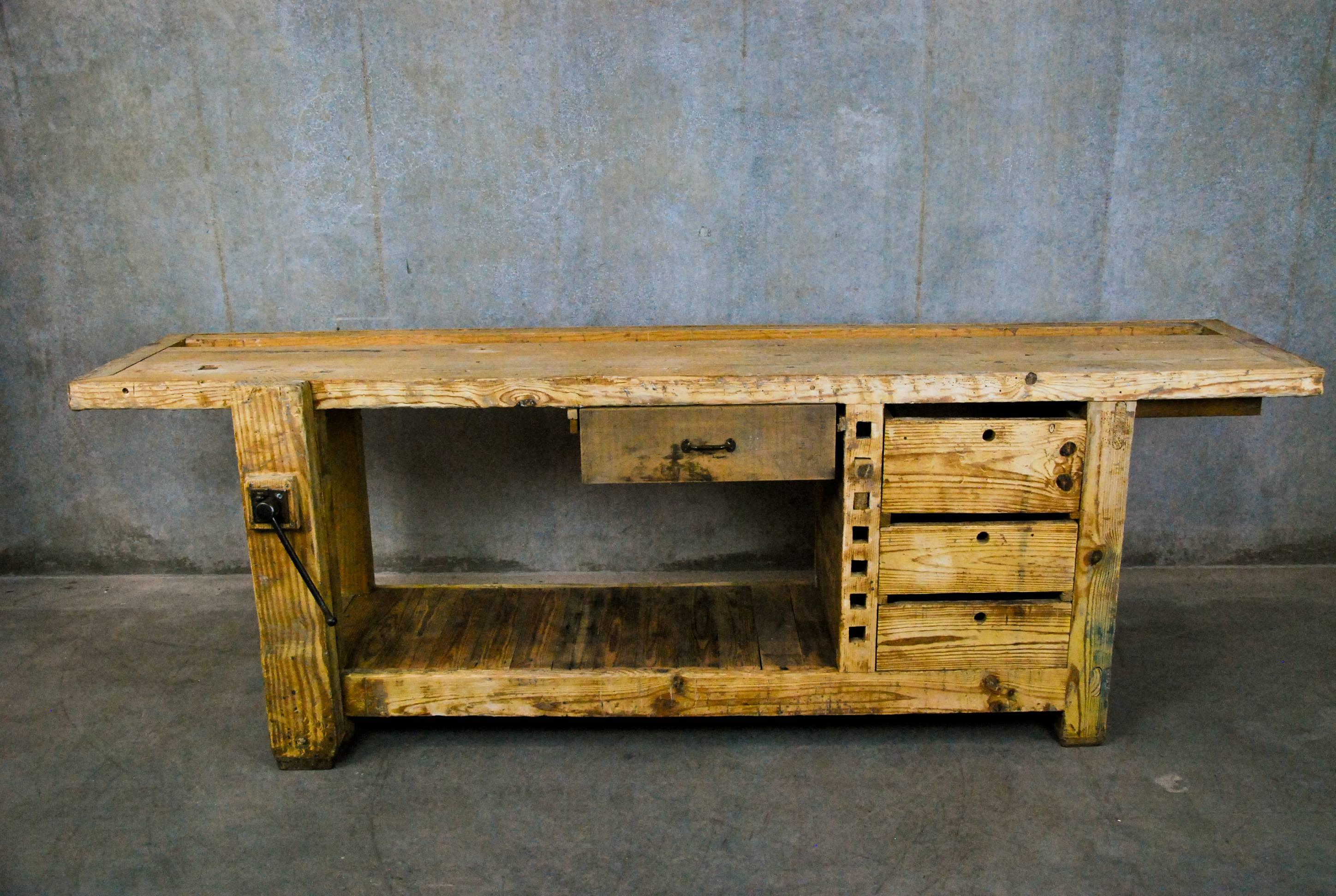 Carpenters bench showing nice wear and patina, showing a set of drawers and bottom storage shelf. We have handled a lot of these and a set of drawers is an uncommon feature.
Very solid, showing good wear.