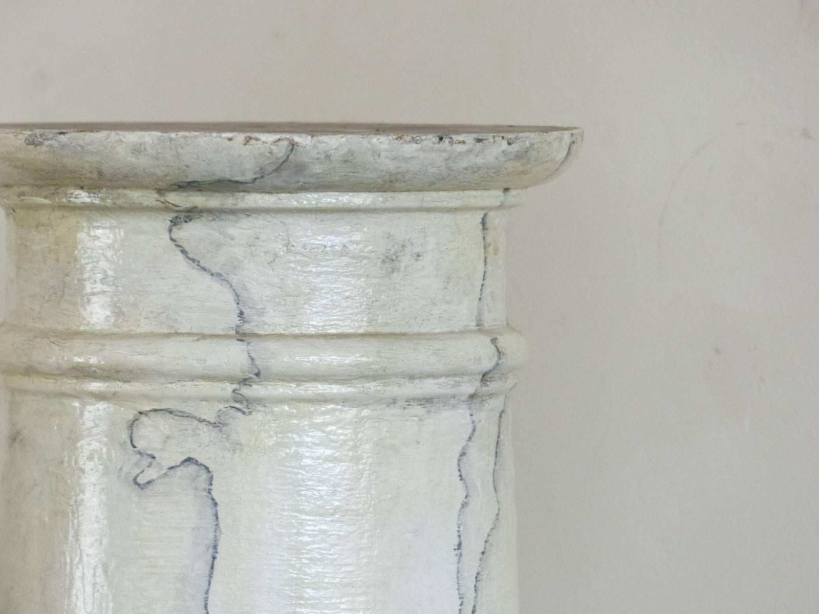 Set of two wooden columns salvaged from a site in Ontario. These wooden accent pieces are complete with caps and bases and are in a faux marble grain paint. The surface is age cracked showing excellent texture.