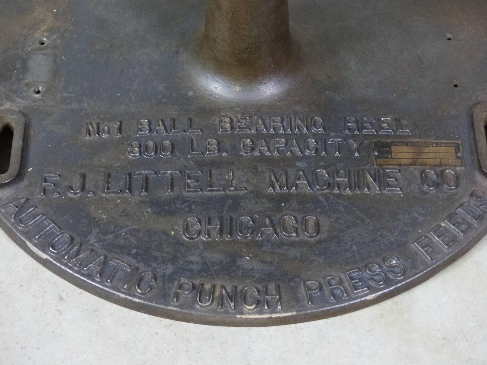 Presented is a wonderful cast iron base from the F.J. Littell  Co Manufacturer 
of industrial  Reels and presses. This selected steel top was most likely adapted to the base for use as a work table. 

Founded in 1918 in Chicago.

Company was