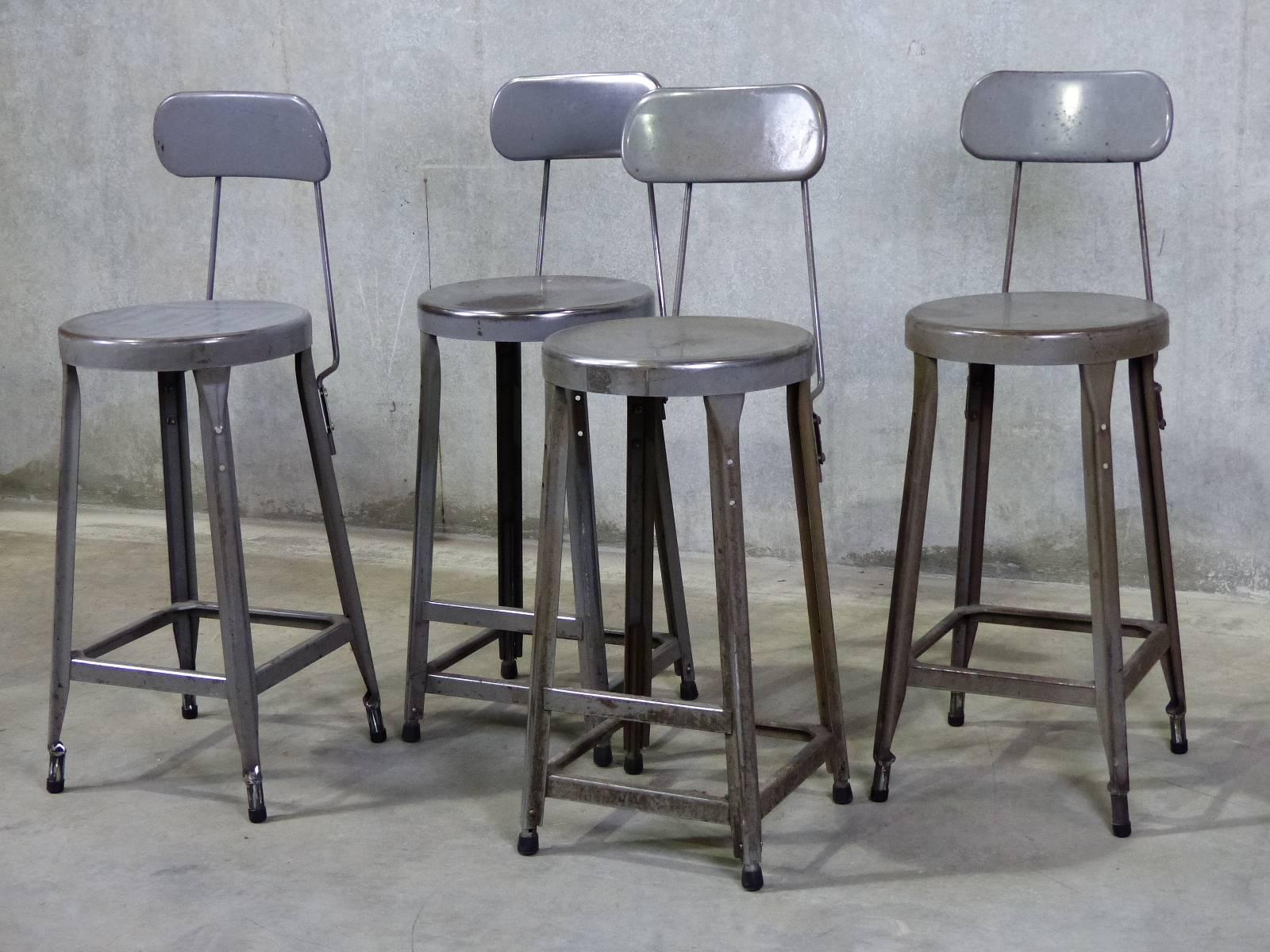 Four solid metal stools manufactured by Standard Equipment in BrookLyn NY.

