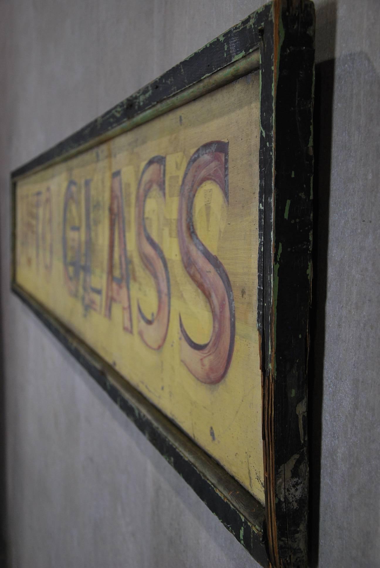As found hand painted sign showing a ghost advertising under the very old crusted surface 