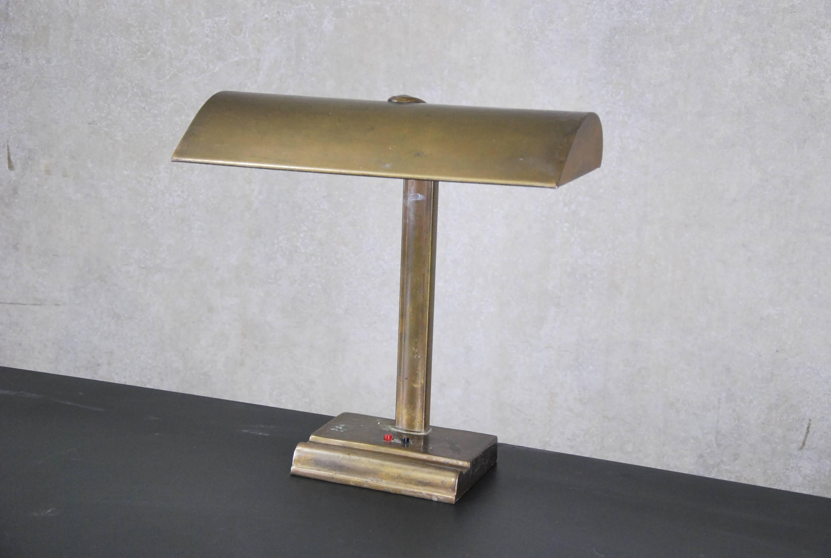 Beautiful simple functioning desk lamp in old brass finish over metal.