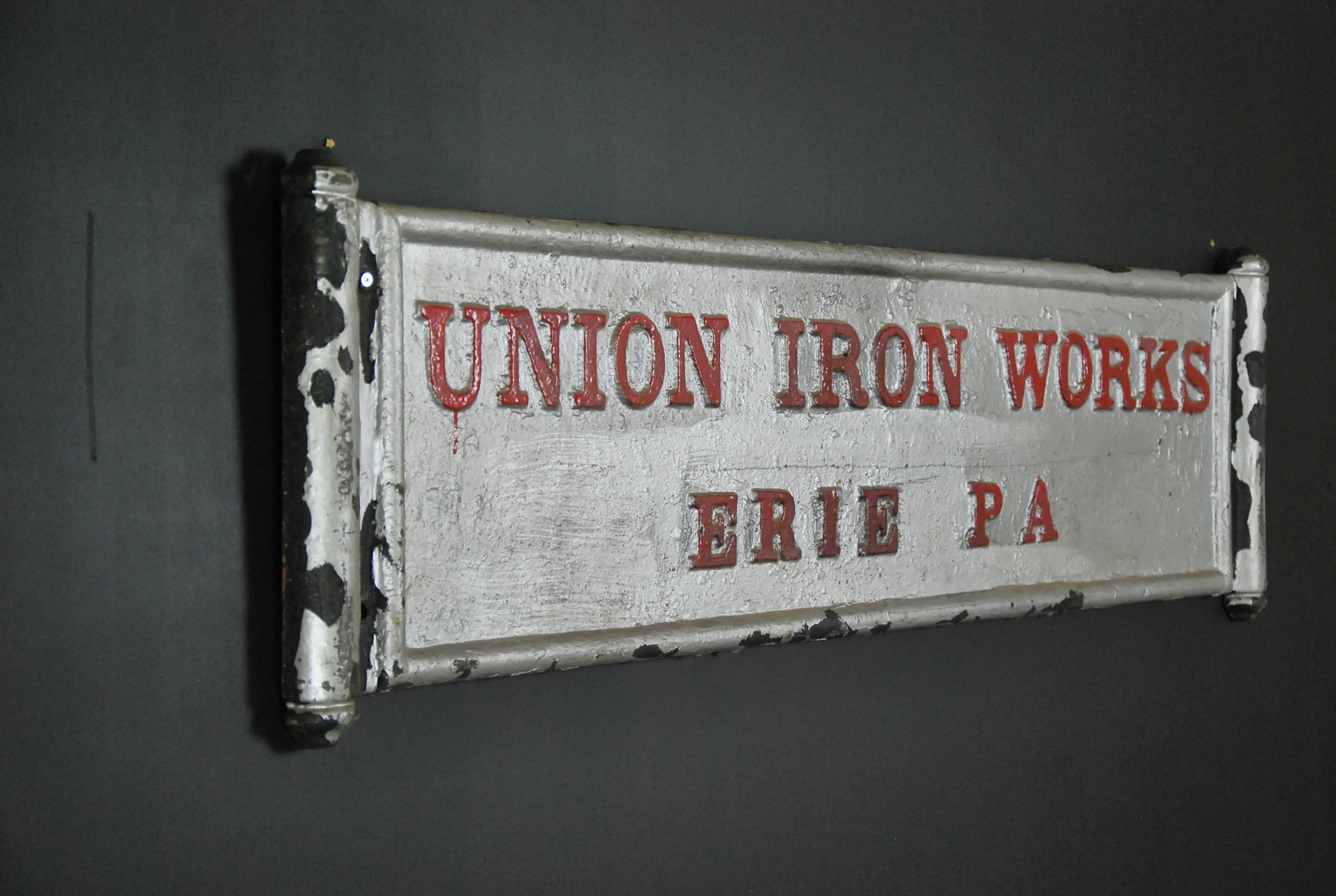 Cast iron wall plaque, in original paint, depicting the 'Union Iron Works Co.' of Erie, PA. This heavy cast sign is in perfect condition and likely graced one of the old mills in steel country. A valuable piece of American history.