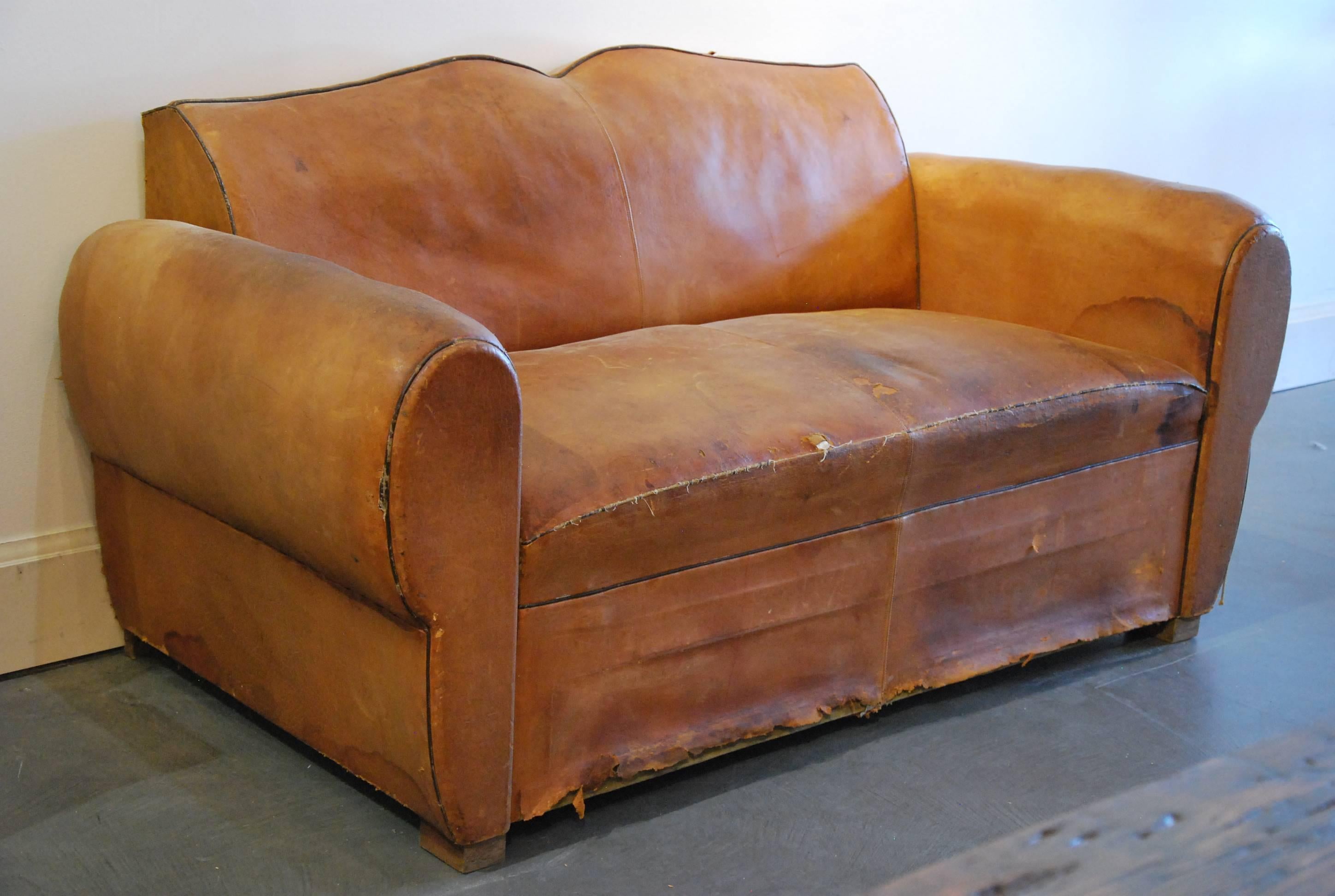 Unusual rare small sofa from France. This set is as found and may require a little love. Structure is heavy has been reinforced and very sound.
Leather is original showing age and minor tears.